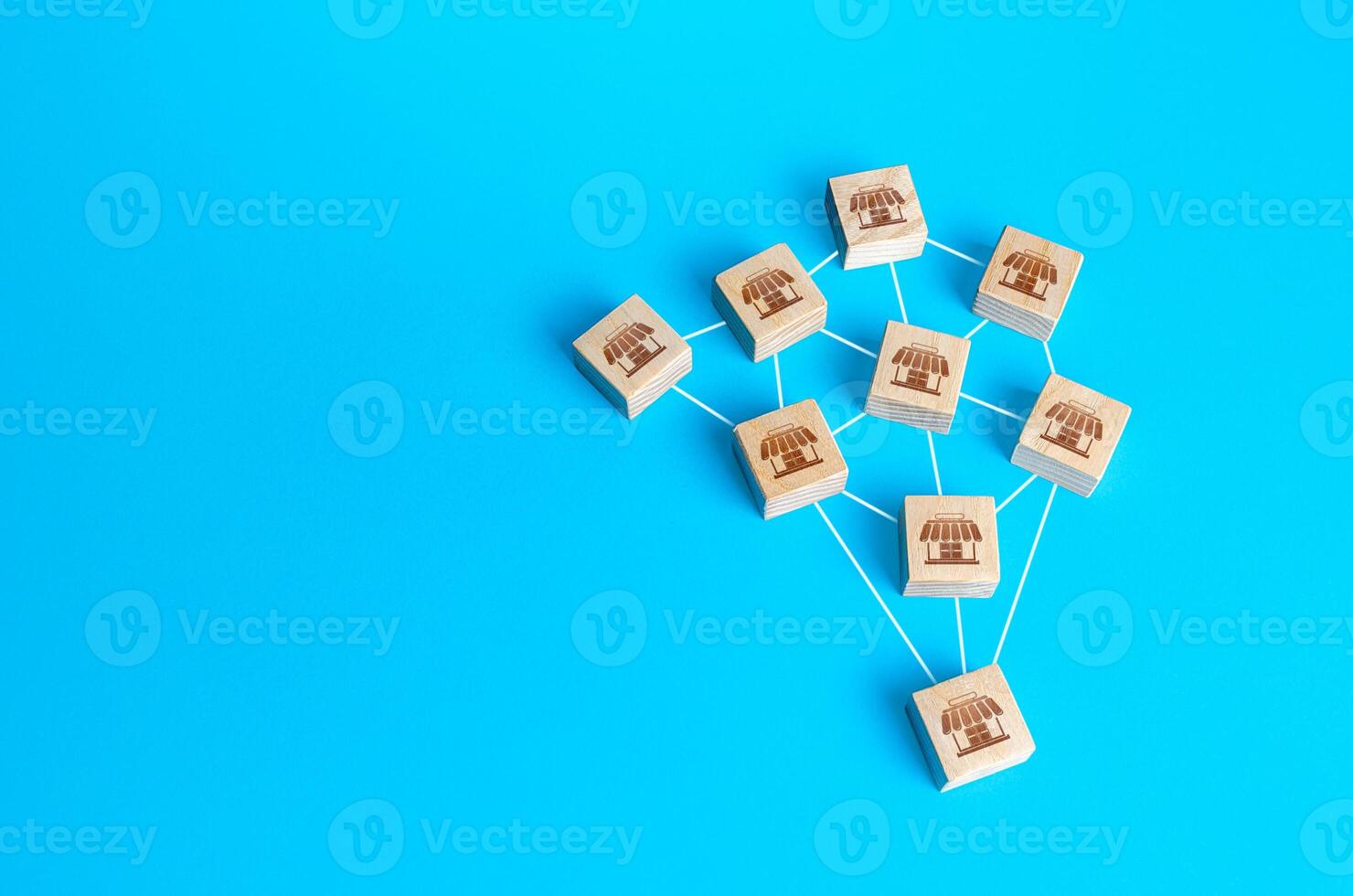 Wooden figurines blocks of shops are interconnected by lines. Building a successful business empire. Merging competitor, creation of a large network monopoly. Franchise concept. Commercial association photo
