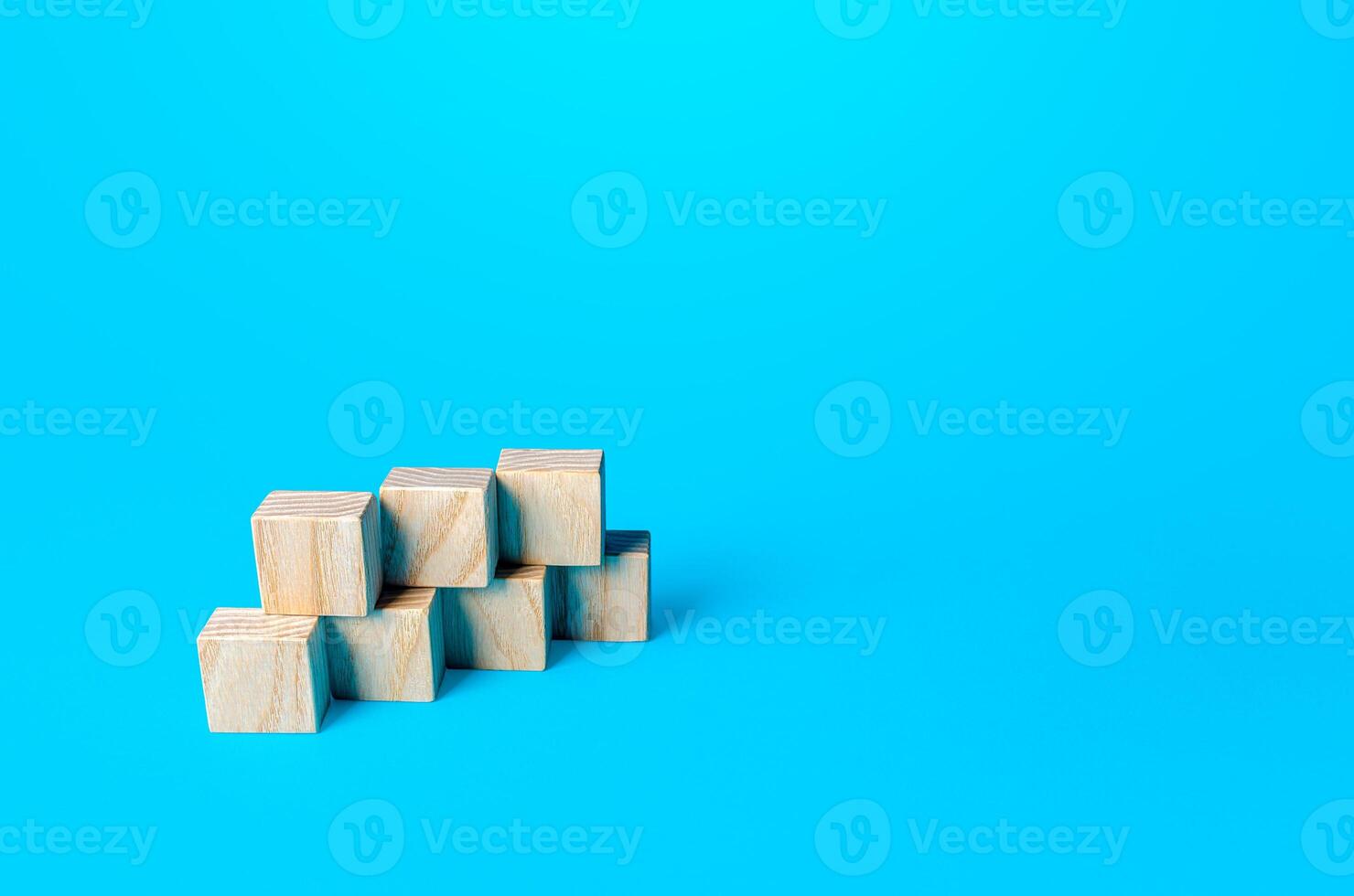 Simple cubic shape assembled from blocks on a blue background. Minimalism. Simple shapes geometry. Slide for presentation. Copy space, place for text. photo
