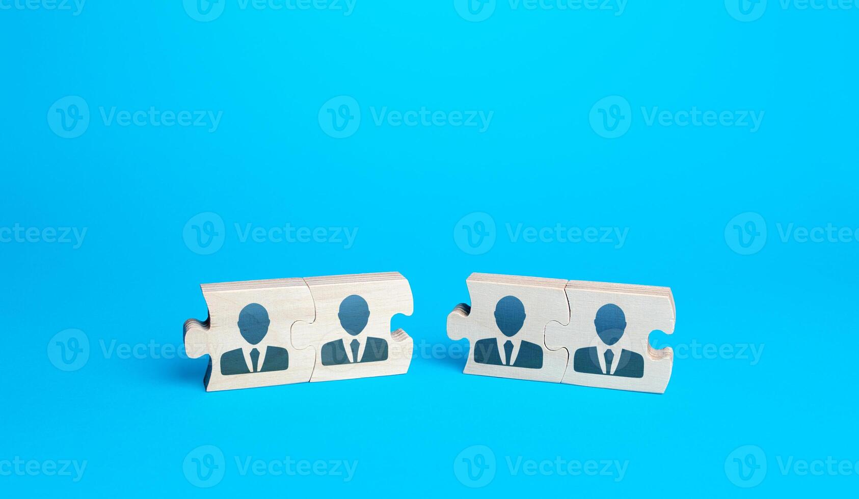 Two groups of puzzles with people on a blue background. Create effective team for a new project. Restructuring, business optimization, HR staff management recruiting. Combining efforts. Cooperation. photo
