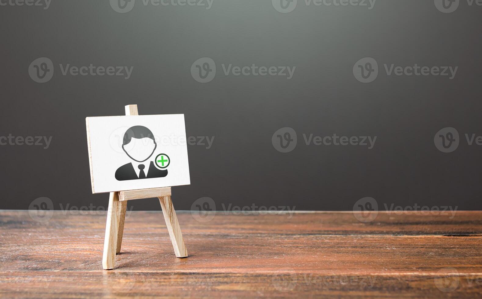 Easel with a symbol of hiring new employees. Help wanted. Recruiting and HR management. Hiring workers, staffing. Headhunters and Human Resources. Search for skilled specialists and professionals. photo