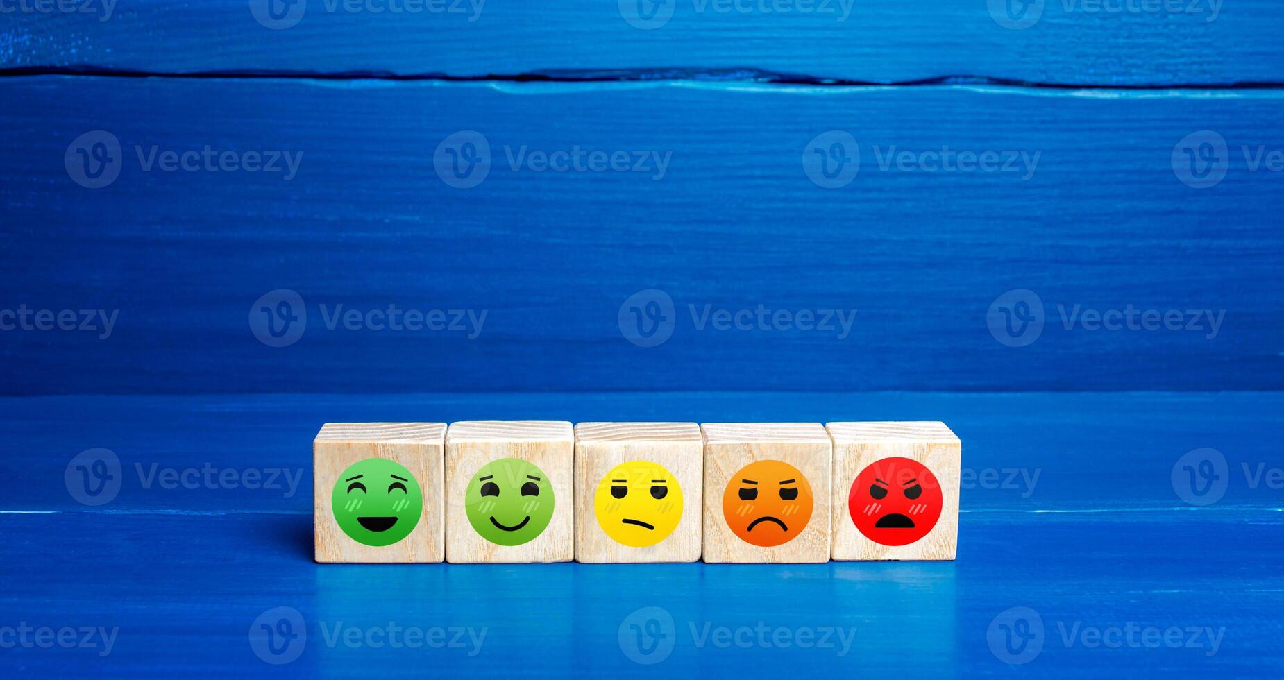 Mood faces from happy to angry on wooden blocks. Concept of rating, review. Visitor satisfaction with the services received. Communication and feedback. Quality assessment, meeting expectations. photo