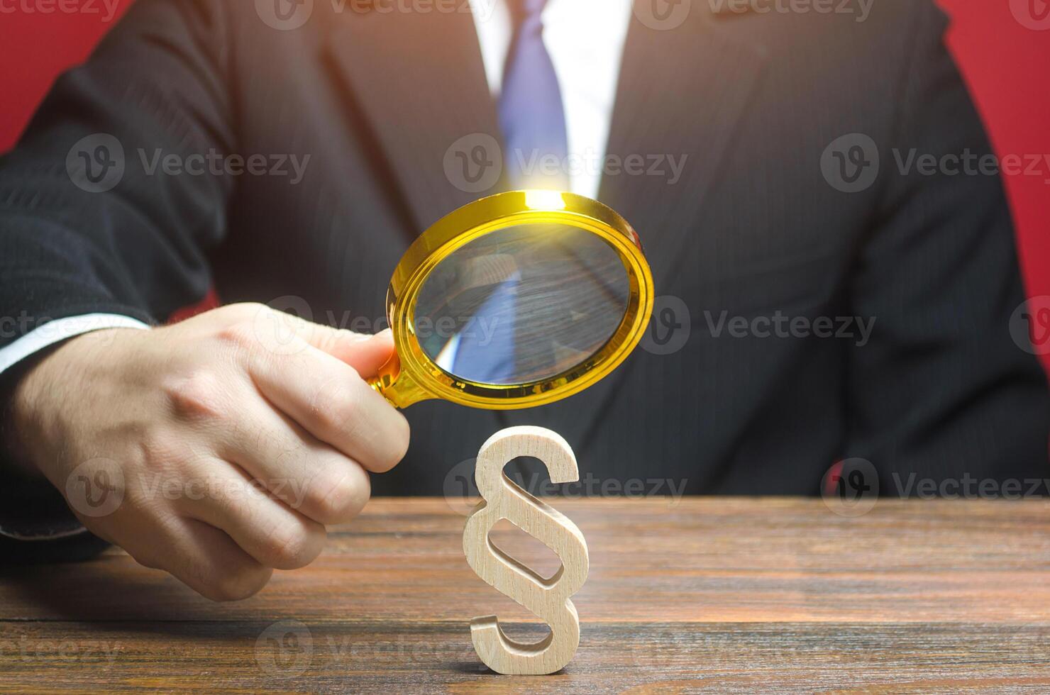 A man examines a paragraph stick figure with a magnifying glass. Lawmaking and legislation. Regulation of rights and obligations. Legal education. Analysis of the legality of acts. Court case photo