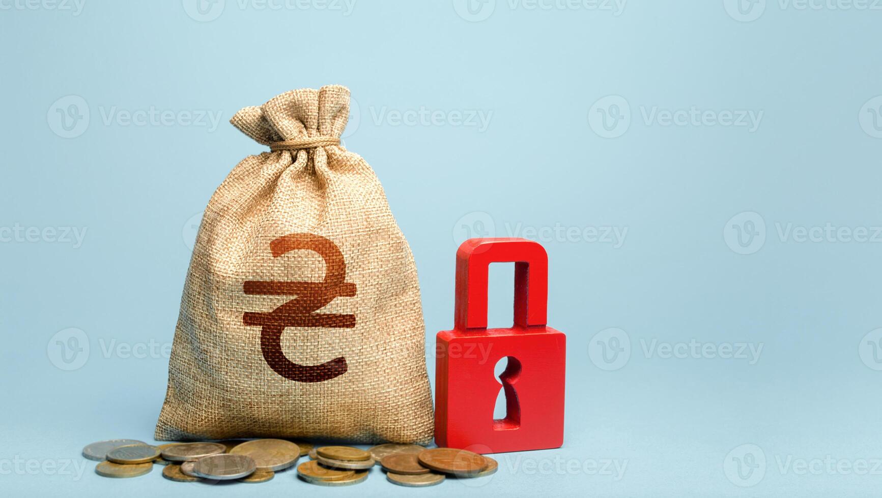 Ukrainian hryvnia money bag and red padlock. Tight government control over the financial system. Cash flow monitoring. Freezing of pension savings. Blocking bank accounts and seizing assets. photo
