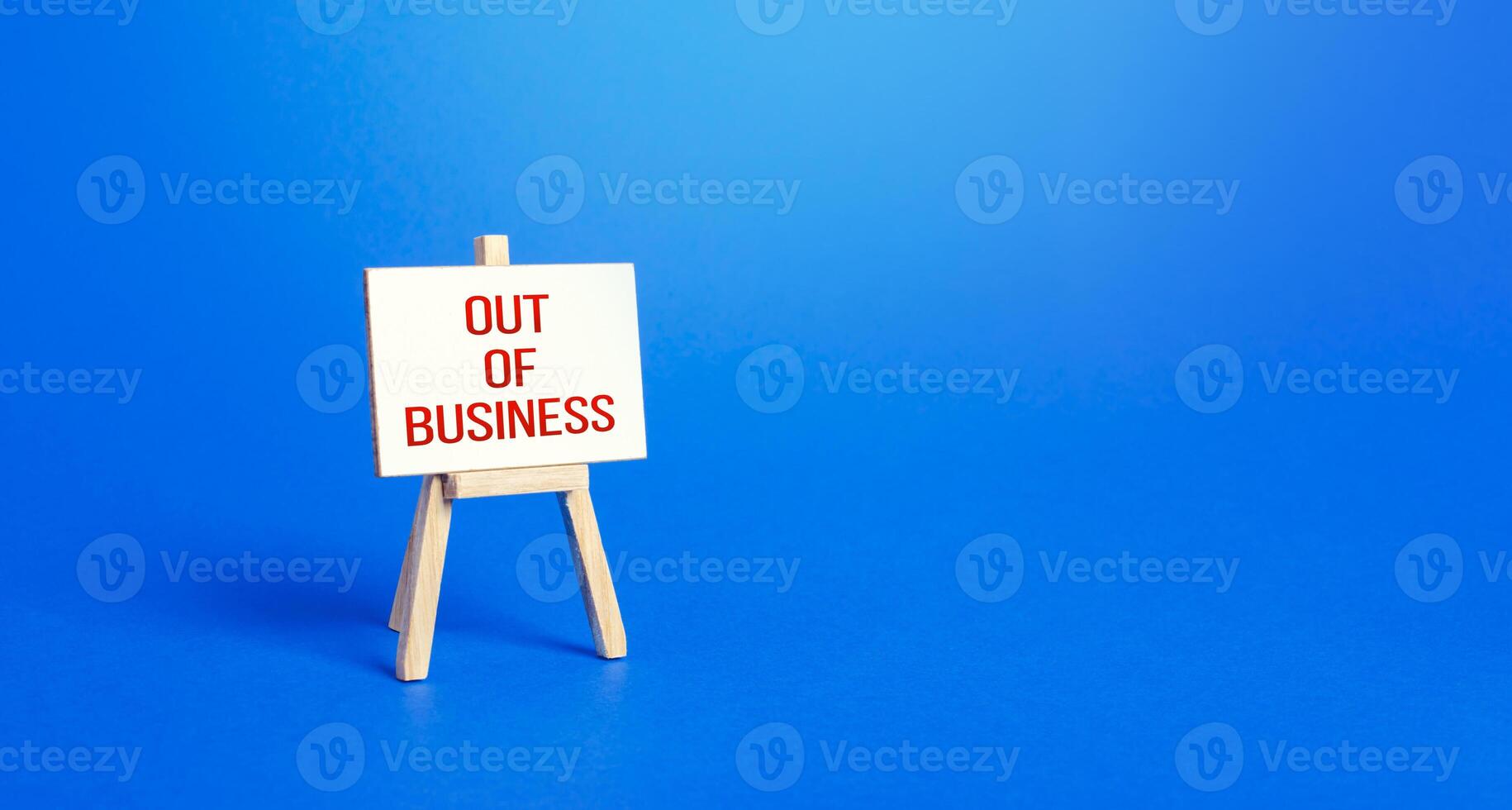 Easel with words went out of business. Bankruptcy and business closure due to the economic crisis and pandemic quarantine measures. Failure of the policy of supporting the economy and entrepreneurs. photo