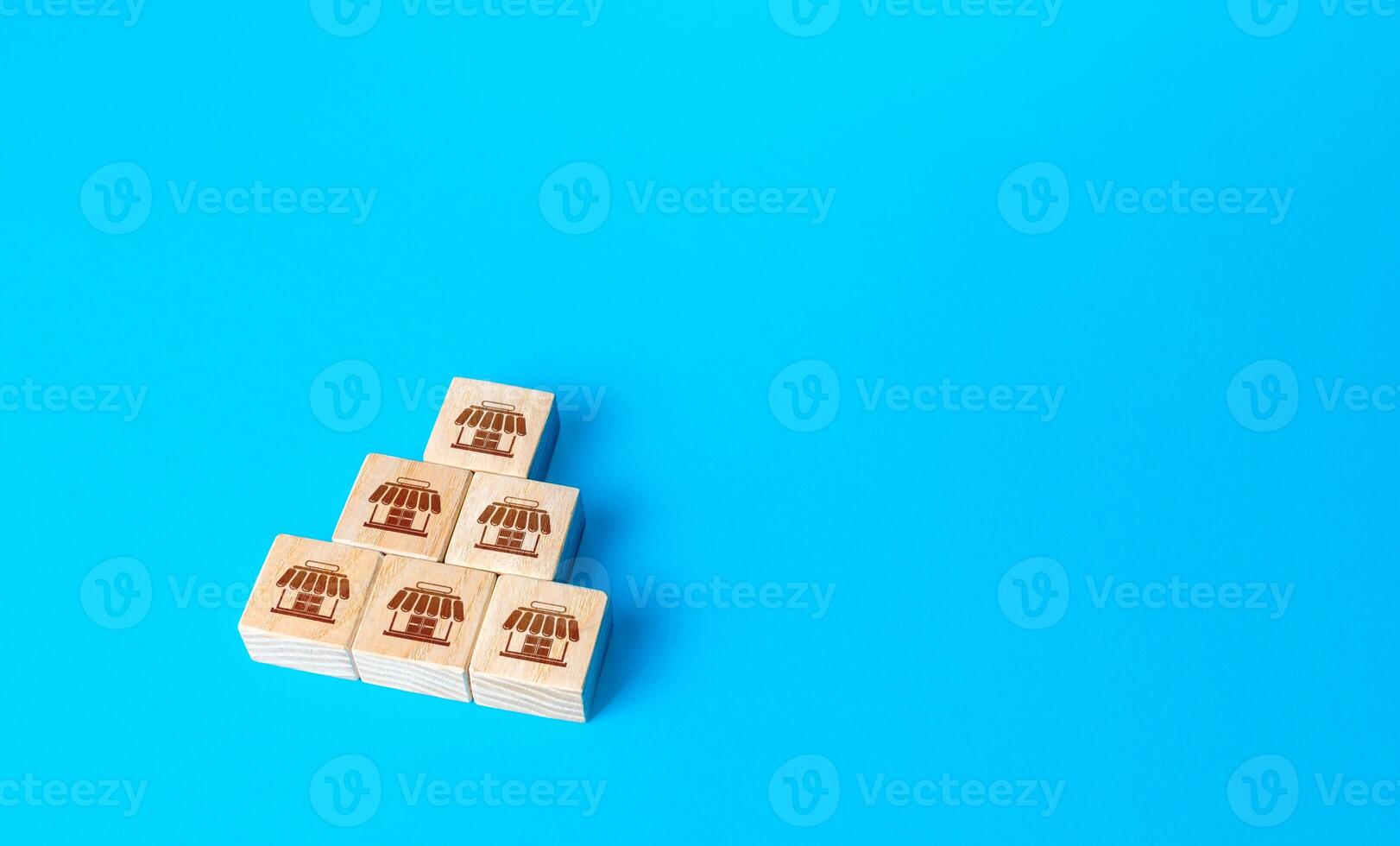 Block pyramid with shop symbols. Franchising concept. Business franchise. Commercial association. Business management. Retail and trade. Organization and structuring. Investment in commerce. photo