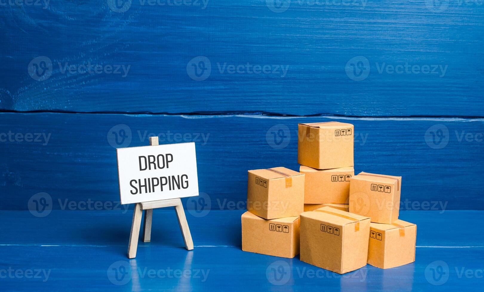 Boxes and easel with Drop Shipping. Business model and supply chain management. Expanding of ways of selling goods. Engaging intermediaries, marketing and advertising. Commerce cooperation, retail. photo