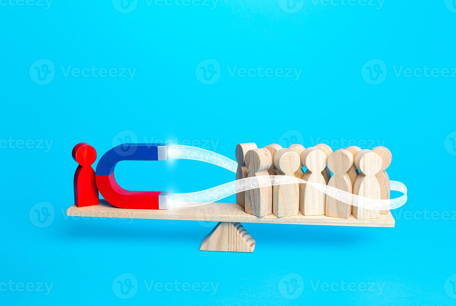 A person attracts people to his side with a magnet. Influence, manipulate the opinion of electorate. Political weight, opinion leader. Collecting support. Endear. Gather followers around an idea photo