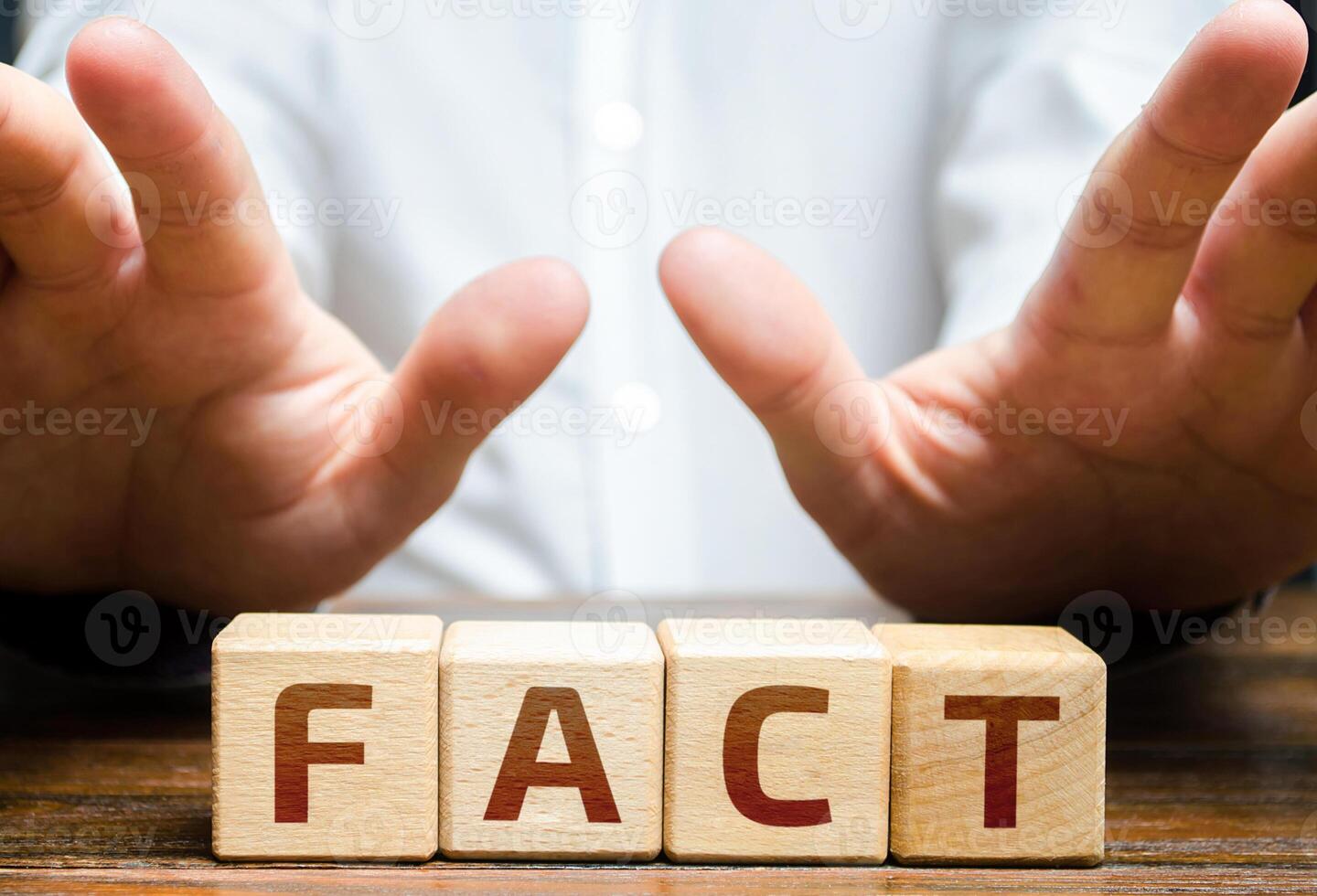 The man fences himself off with his hands from the word Fact. Denial and non-acceptance rejection of facts and evidence. Conspiracy and mistrust of official reliable sources of information photo