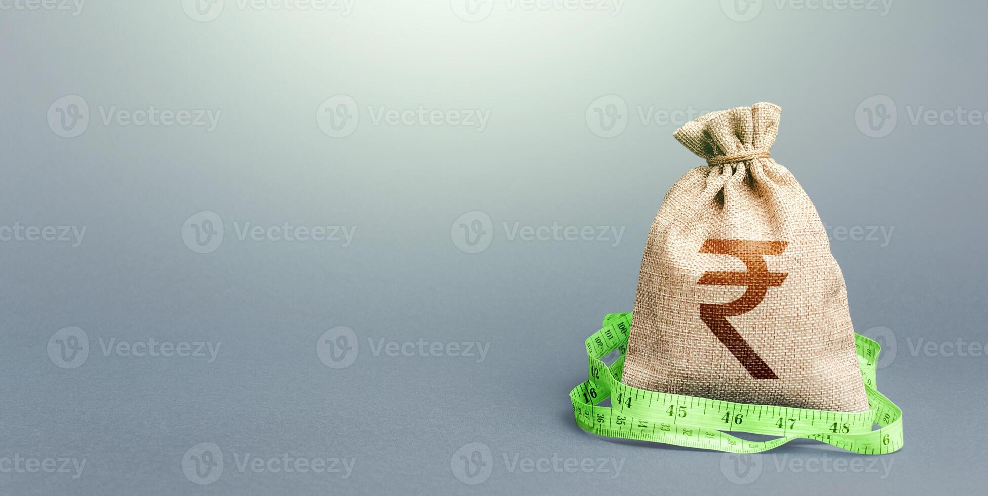 Indian rupee money bag and measuring tape meter. Analysis of economic situation. Formation and optimization of the budget, savings. Declaration of income, illegal enrichment. Assessment of capital. photo