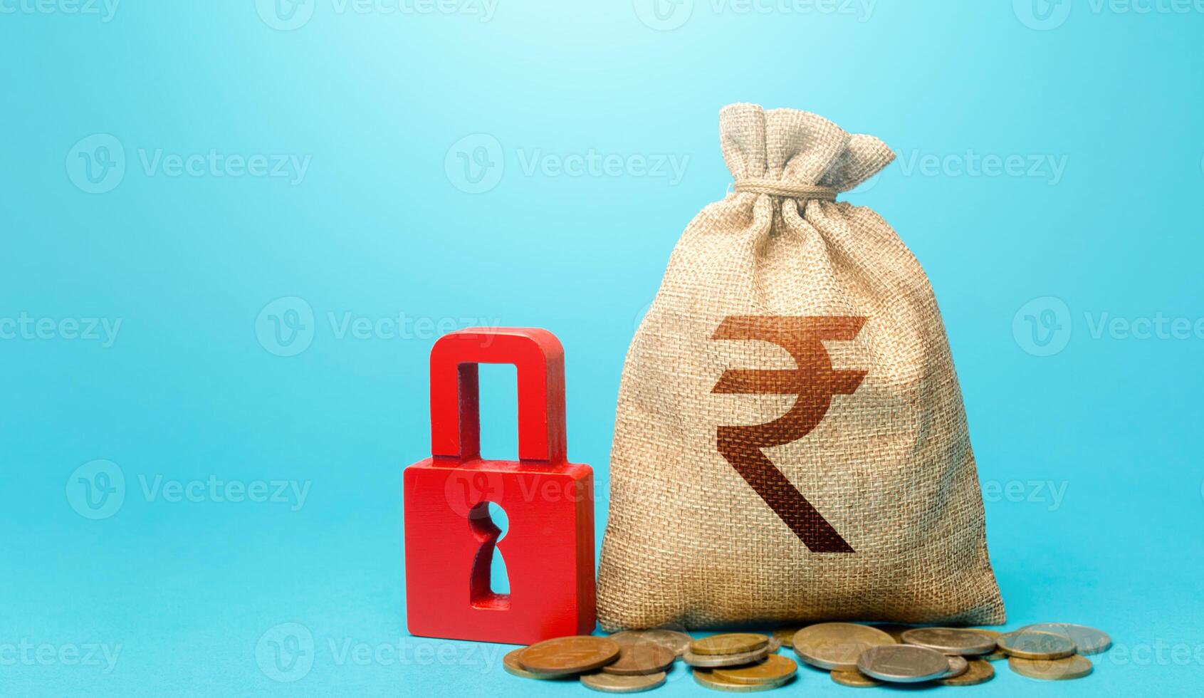 Indian rupee money bag and red padlock. Blocking bank accounts and seizing assets. Freezing of pension savings. Cash flow monitoring. Tight government control over the financial system. photo