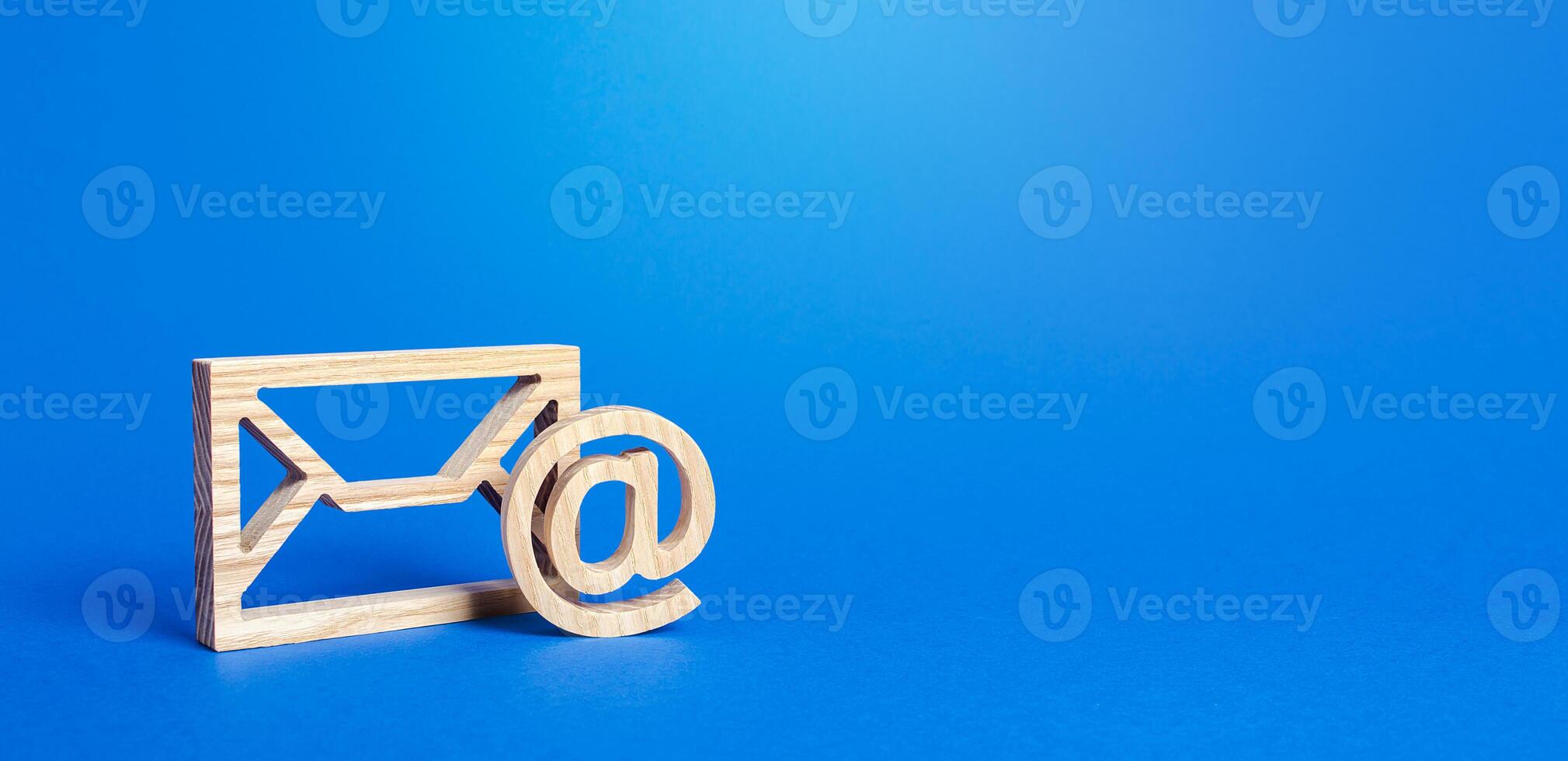 Email figure on blue background. Envelope and AT commercial sign symbol. Concept of email address. Contacts and communication. Business representations on the Internet and social media. Feedback photo