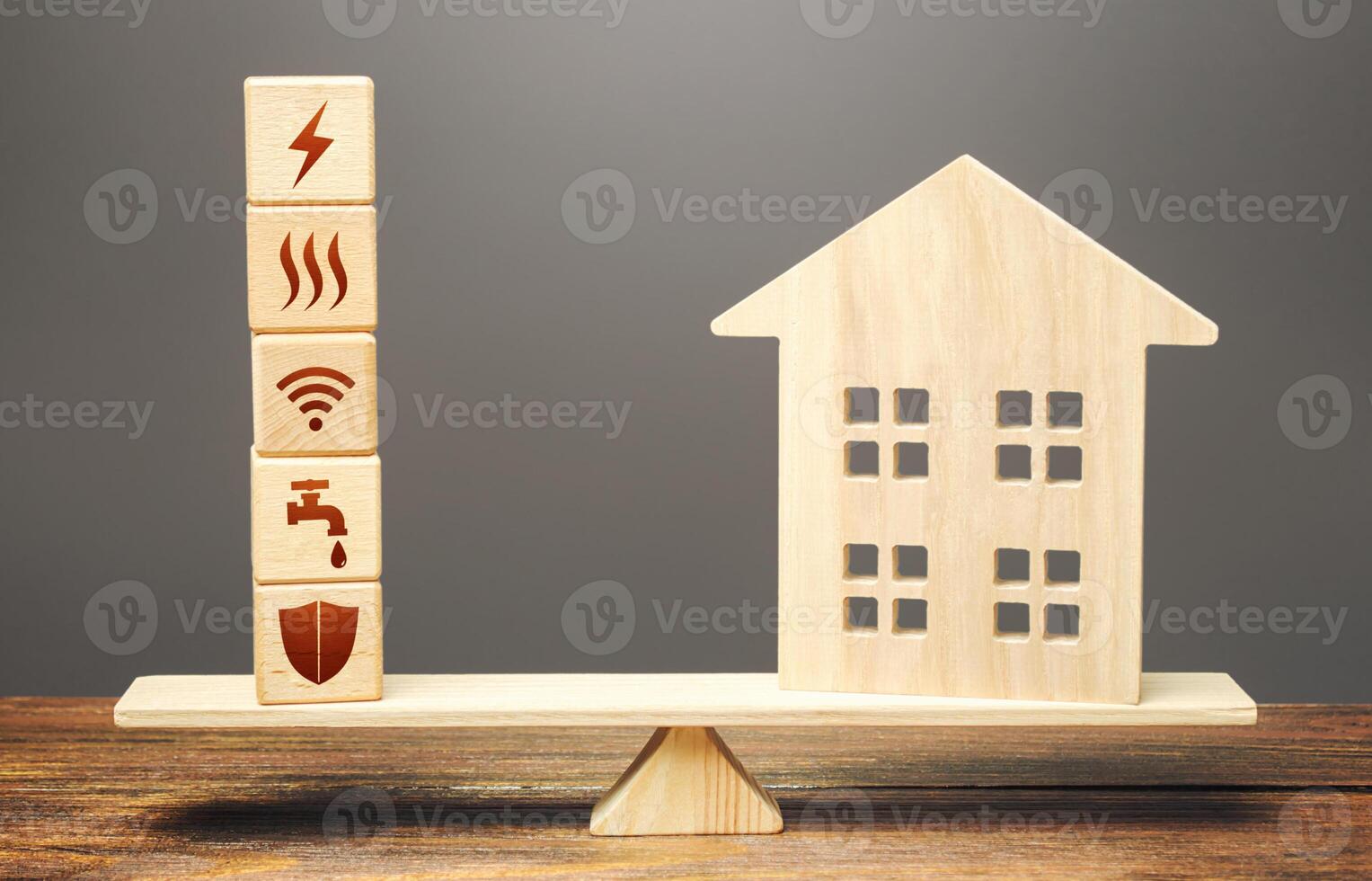 House and blocks with utilities public service symbols on scales. Availability of bill payment. Home is too big and its maintenance costs are high. Improve water and energy efficiency. Energy saving photo