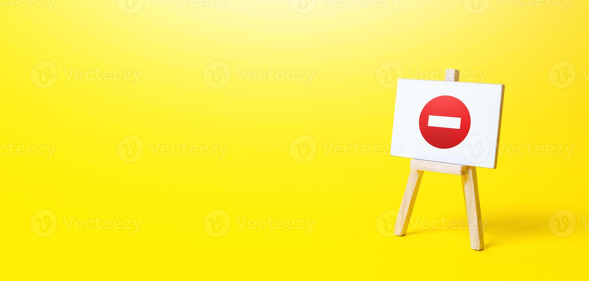 Easel with no entry symbol. Prohibition of actions and operations, restricted area. Ban and sanctions. Wrong direction. Failed strategy. Inaccessibility, taboo. Blocking, imposing restrictions. photo