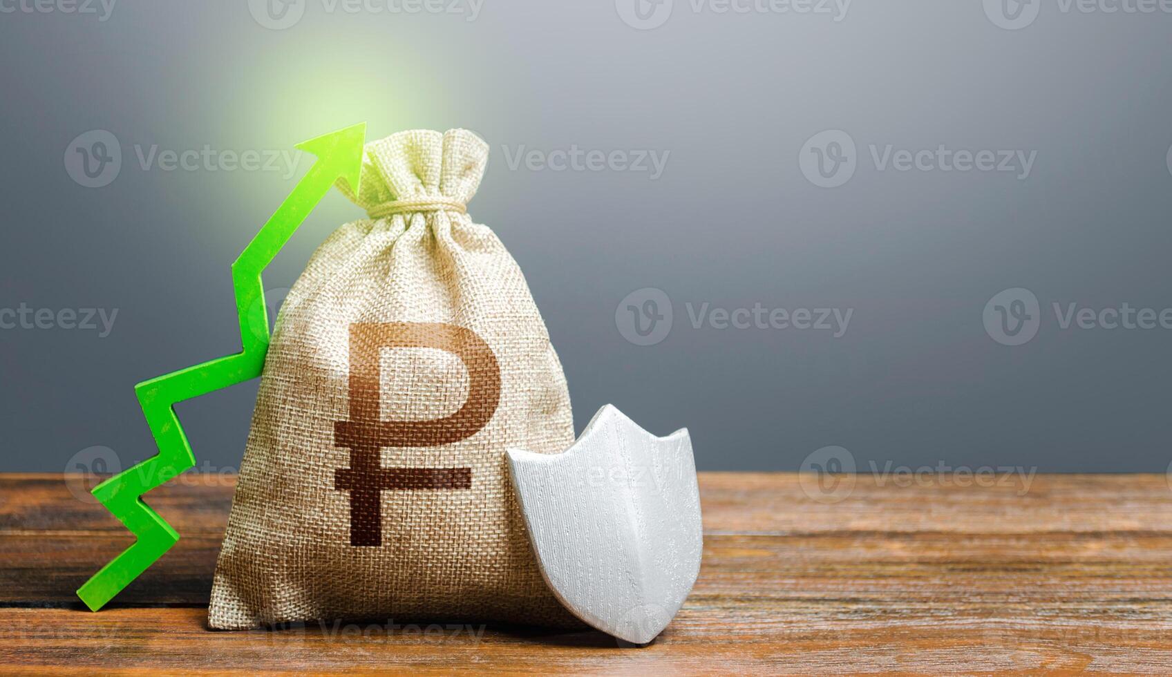 Russian ruble money bag with a shield and a green arrow up. Safety security of investments, financial system stability. Increasing maximum amount of guaranteed deposits insurance compensation. photo