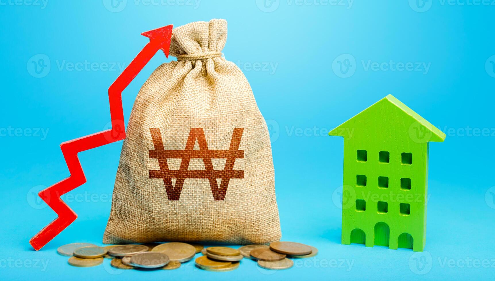 South korean won money bag with red up arrow and residential building. Return on investment. Increase in prices for apartments and housing. Recovery and growth in property cost. Municipal budget. photo