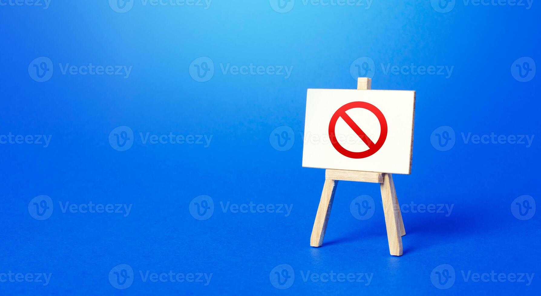 Easel with the prohibition sign NO on a blue background. Restricted area. Restrictions and Sanctions. Out of stock. Ban and Embargo. Failed strategy. Inaccessibility, taboo. Blocking. photo