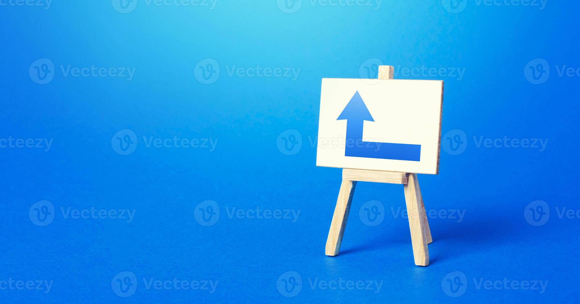 Easel with a blue left arrow. Direction to go around on the right. Advertising, indicating the location of the store object. Minimalism. Navigation, customer acquisition. Copy space photo