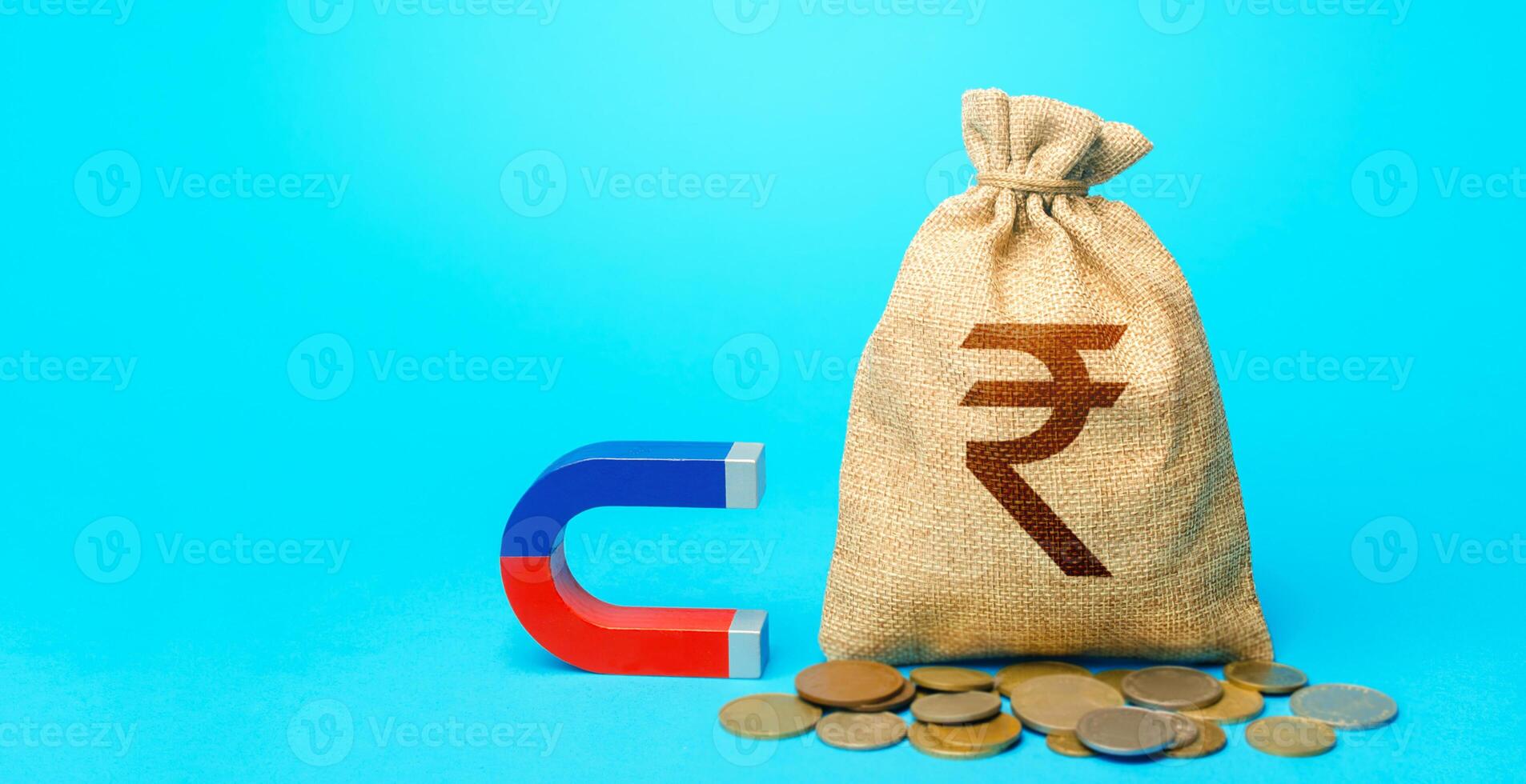 Indian rupee money bag and magnet. Raising funds and investments in business projects and startups. Money laundering. Tax collection. Accumulation and attraction of capital. photo