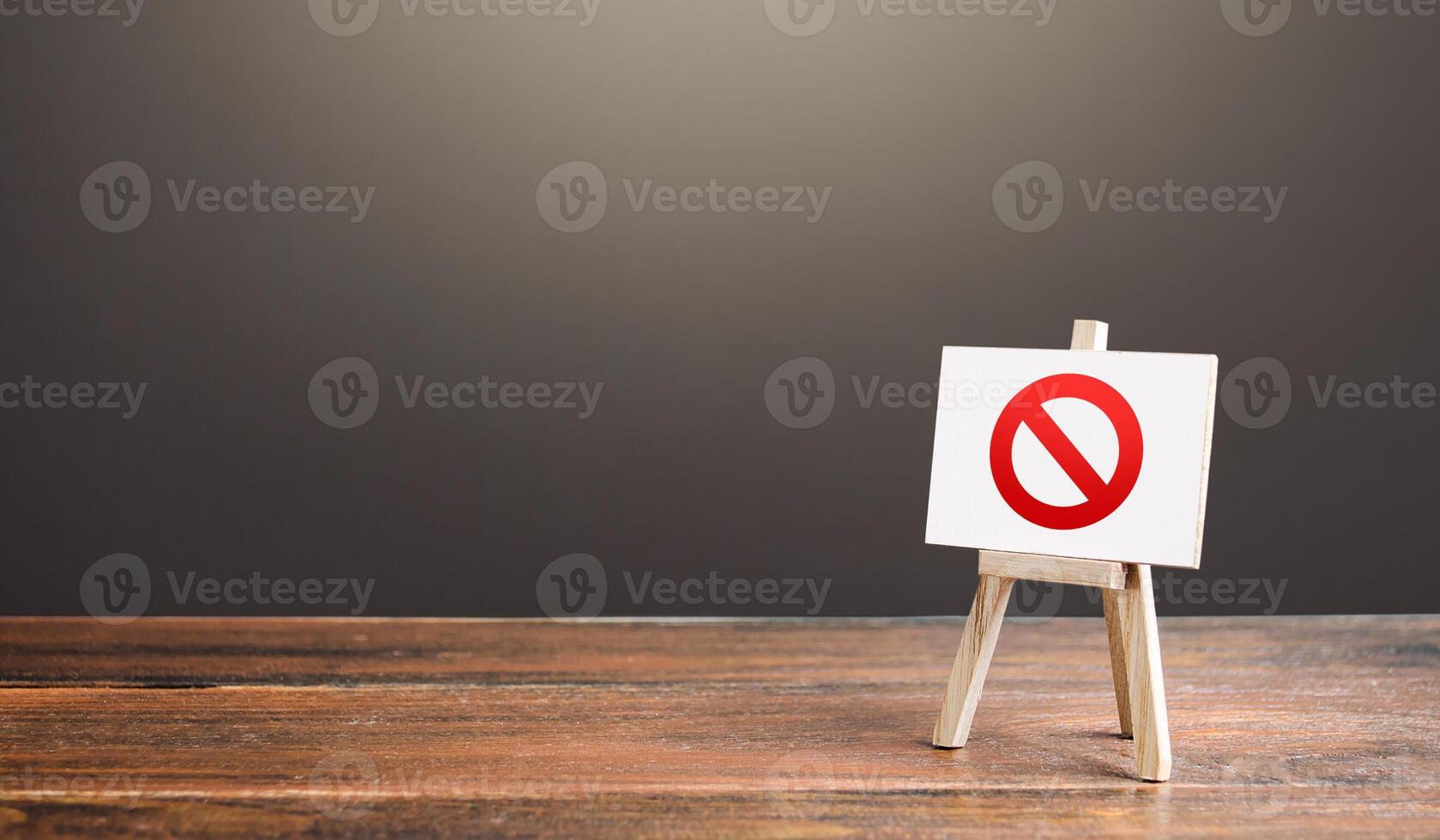 Easel with the prohibition sign NO. Restricted area. Restrictions and sanctions. Inaccessibility. Blocking. Out of stock. Ban and Embargo. Failed strategy. Denying entry, stopping action processes. photo