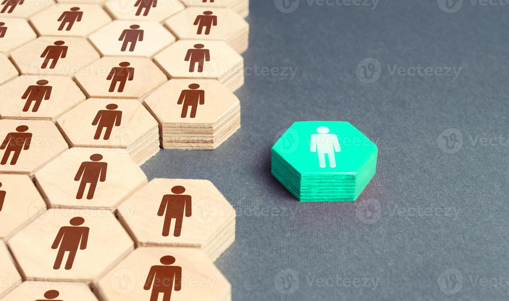 Human figurine outside company's overall system. Separation from group, promotion. To be different. Recruiting new employees to vacant places. Key person, team leader. Cooperation improves efficiency. photo