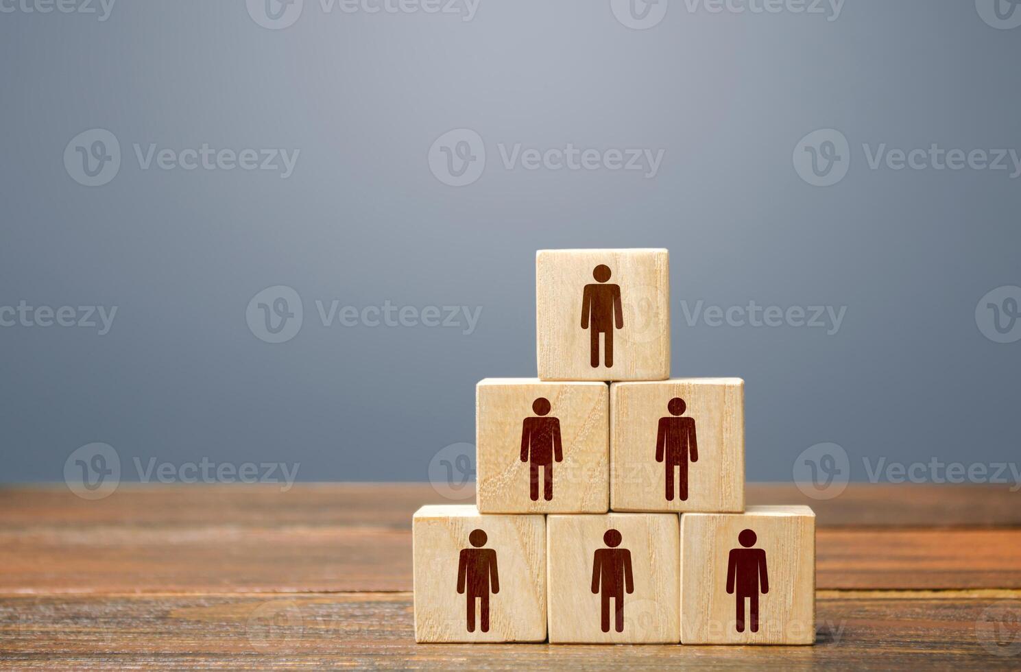 Blocks pyramid with people. Joint efforts to achieve goal. Teamwork, cooperation and collaboration. Team building, company hierarchical power vertical system. Strength in unity. Joining around idea photo