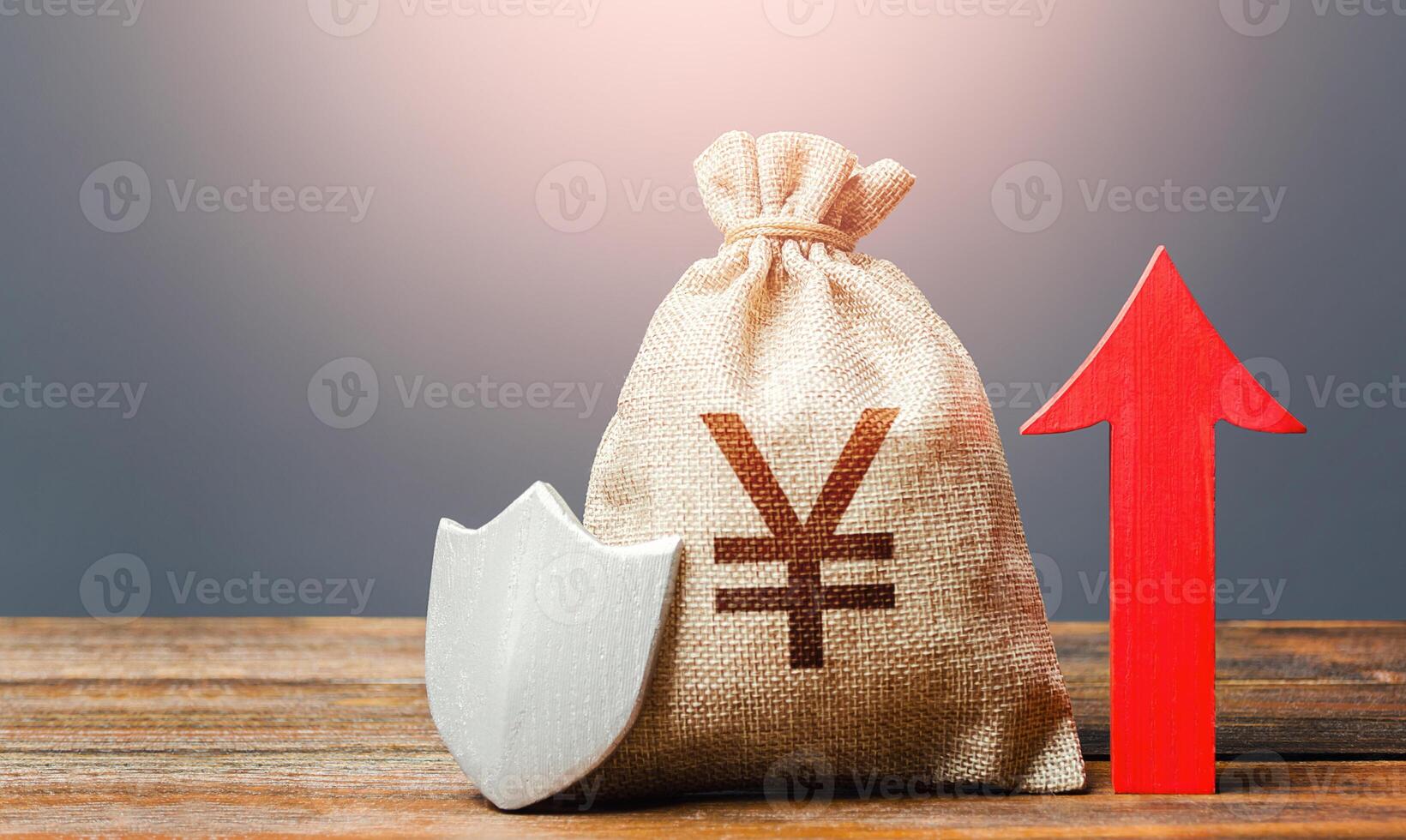 Yen Yuan money bag with a shield and a red arrow up. Safety of investments, savings. Increasing the maximum amount of guaranteed insurance compensation for deposits. Financial stability. photo