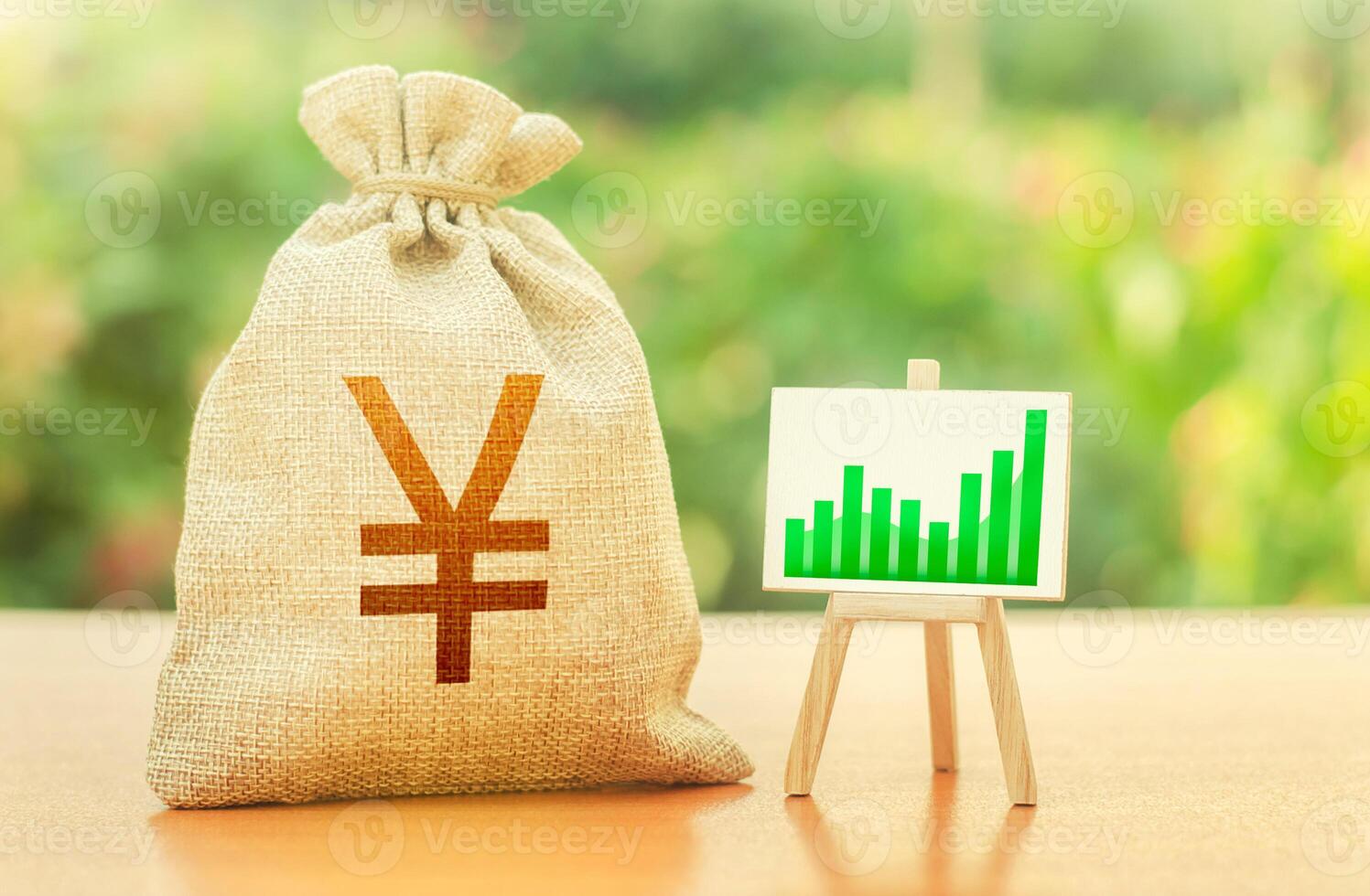 Yen Yuan money bag and easel with green positive growth graph. Recovery and growth of economy, good investment attractiveness. Economic development. Business sentiment. High deposits profitability. photo