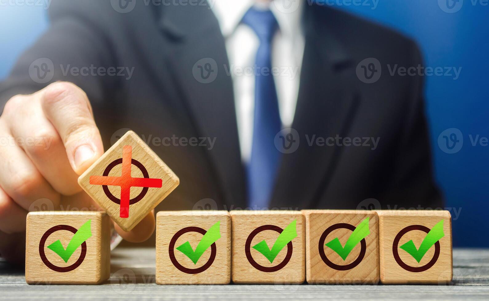 Man breaks a row of check boxes ticks with a red X. Intentional violation of the terms of the contract, termination of deal. Creation of artificial bureaucratic obstacles, corruption. Sabotage photo