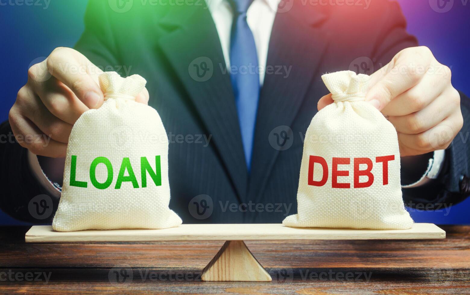 A businessman holds bags with a loan and debt on scales. Financial system balance difficulties. Borrow loans to pay off debts load, debt restructuring. Avoiding default bankruptcy, business support. photo