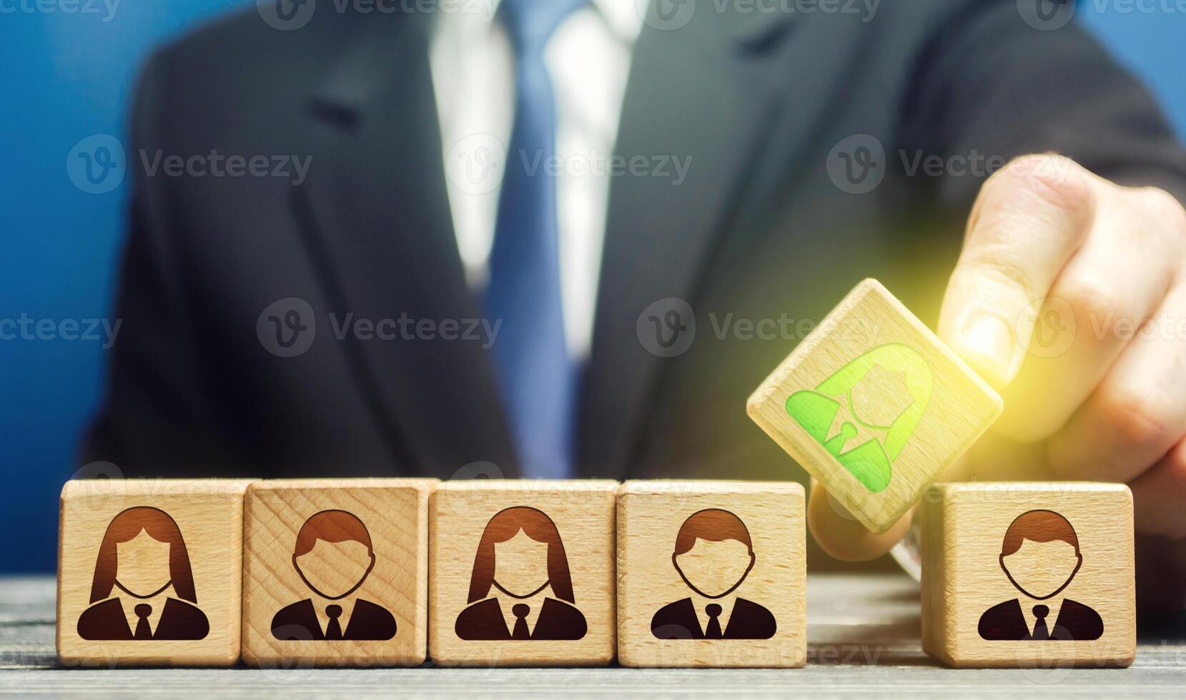 A businessman appoints a leader to a team. Leadership skills. Promising talented employee. Formation effective working group. Implementation of specialists professionals in to staff. Management photo