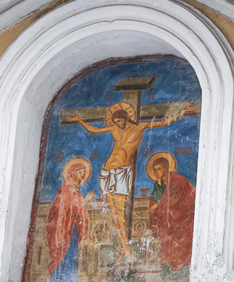 Yaroslavl, Russia - November 17, 2024 Crucifixion of Jesus, an ancient fresco on the wall of the monastery photo