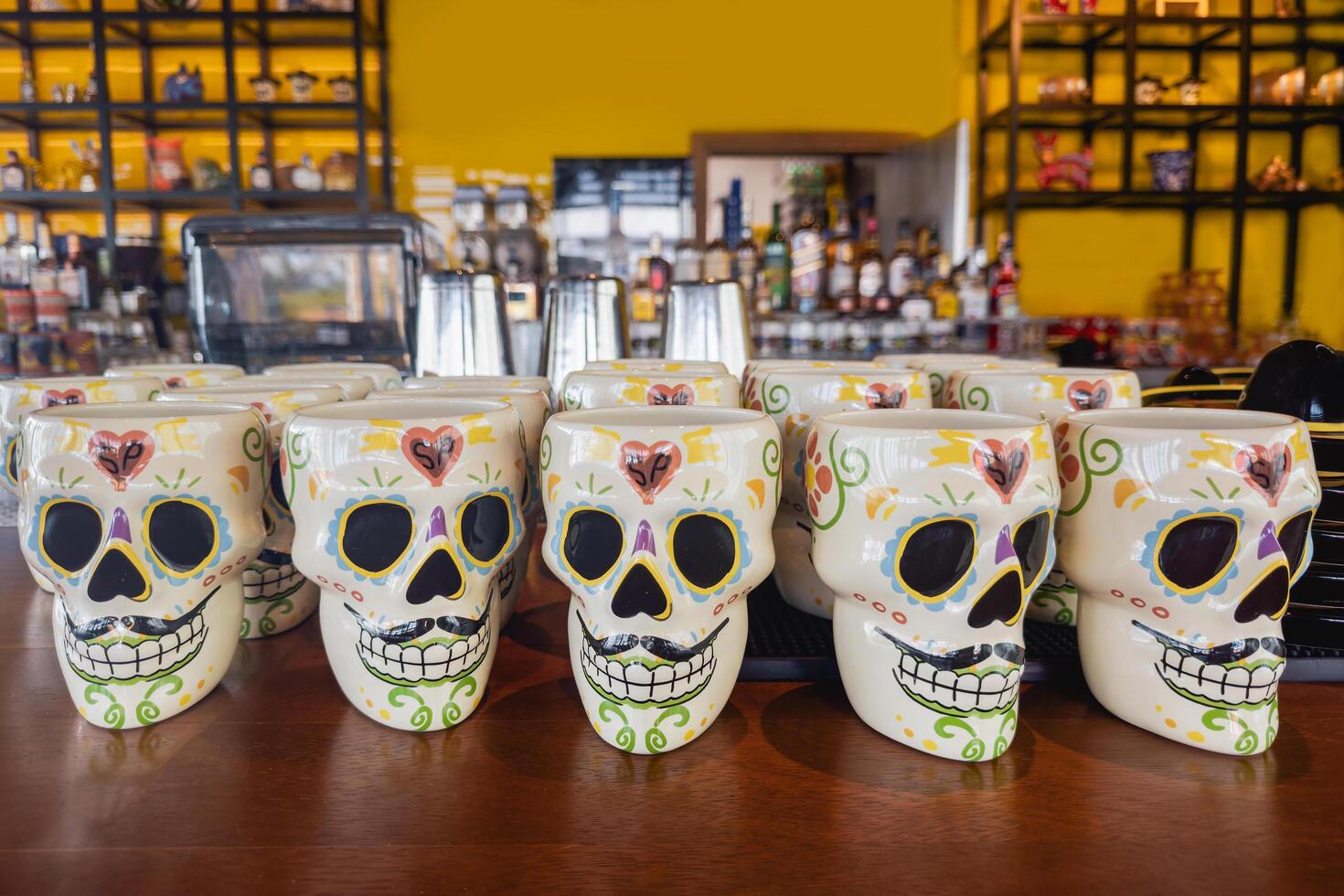 Dubai, UAE - May 28, 2024 Mexican multicolored mugs in the shape of a skull photo