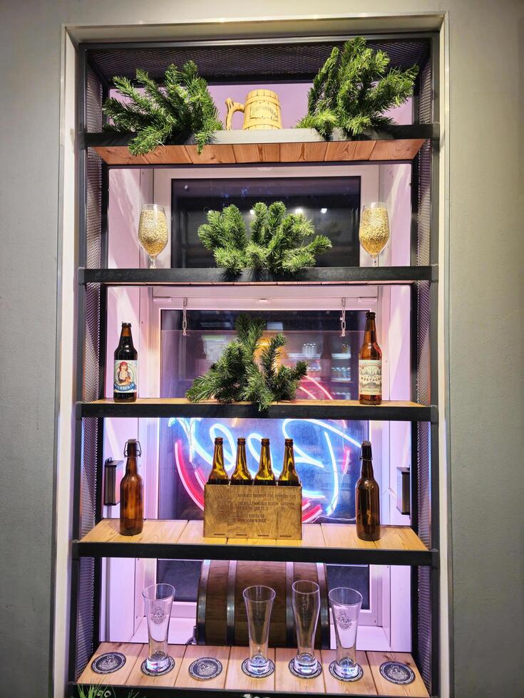 September 30, 2024, Saint Petersburg, Russia Bottles of craft beer are displayed on a shelf in the brewery photo