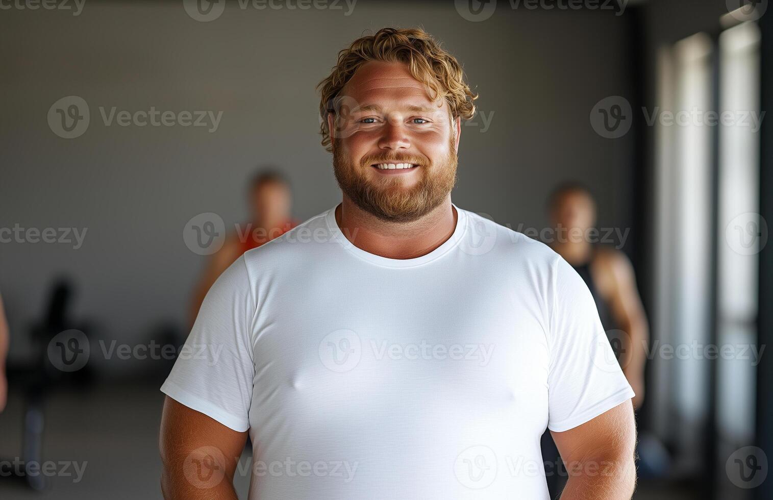 a man with a beard standing in front of a group of people photo
