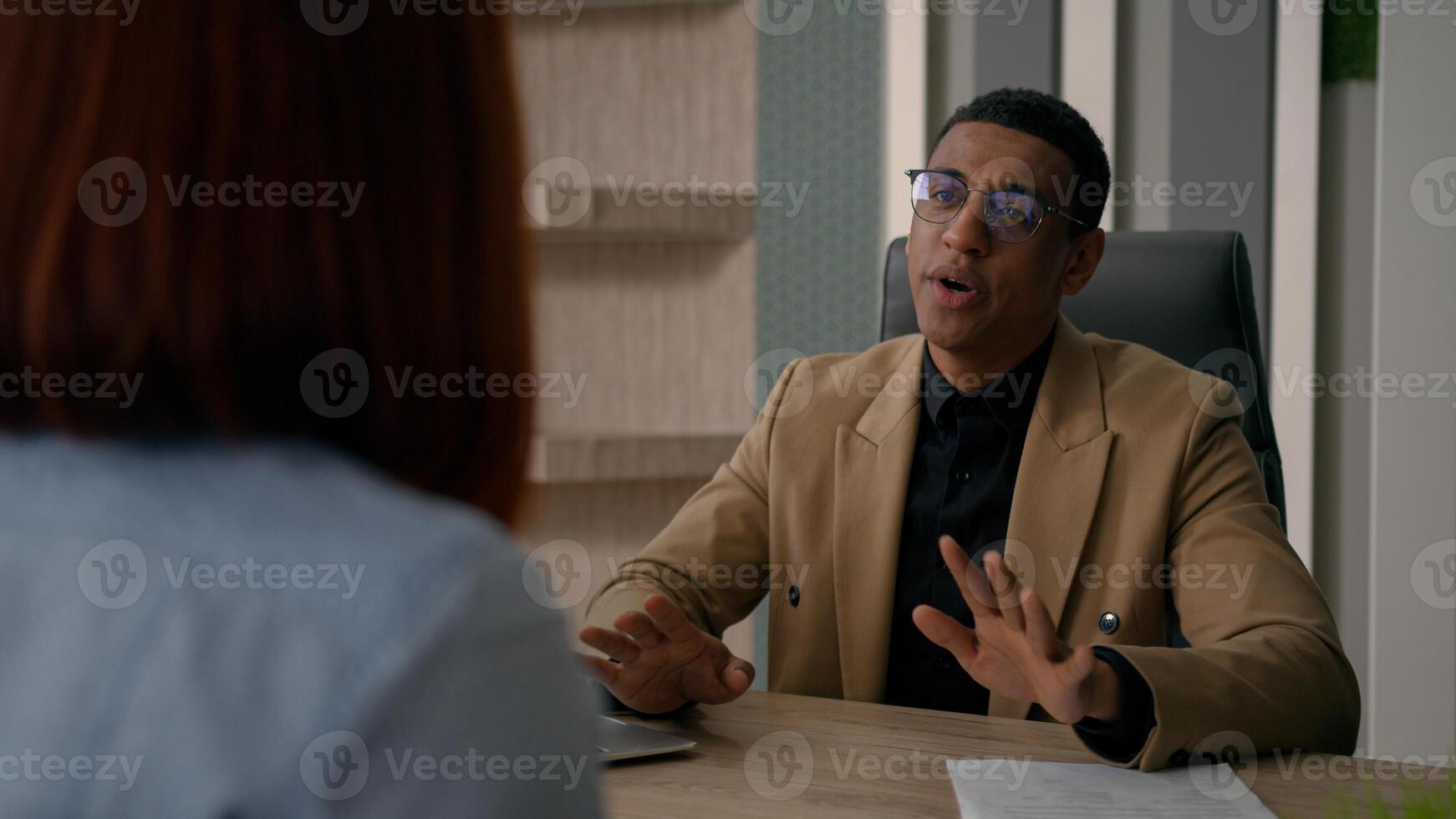 African American man businessman HR manager trader estate agent salesman consulting woman customer job interview recruitment consultation with client two business partners talk at office negotiation photo