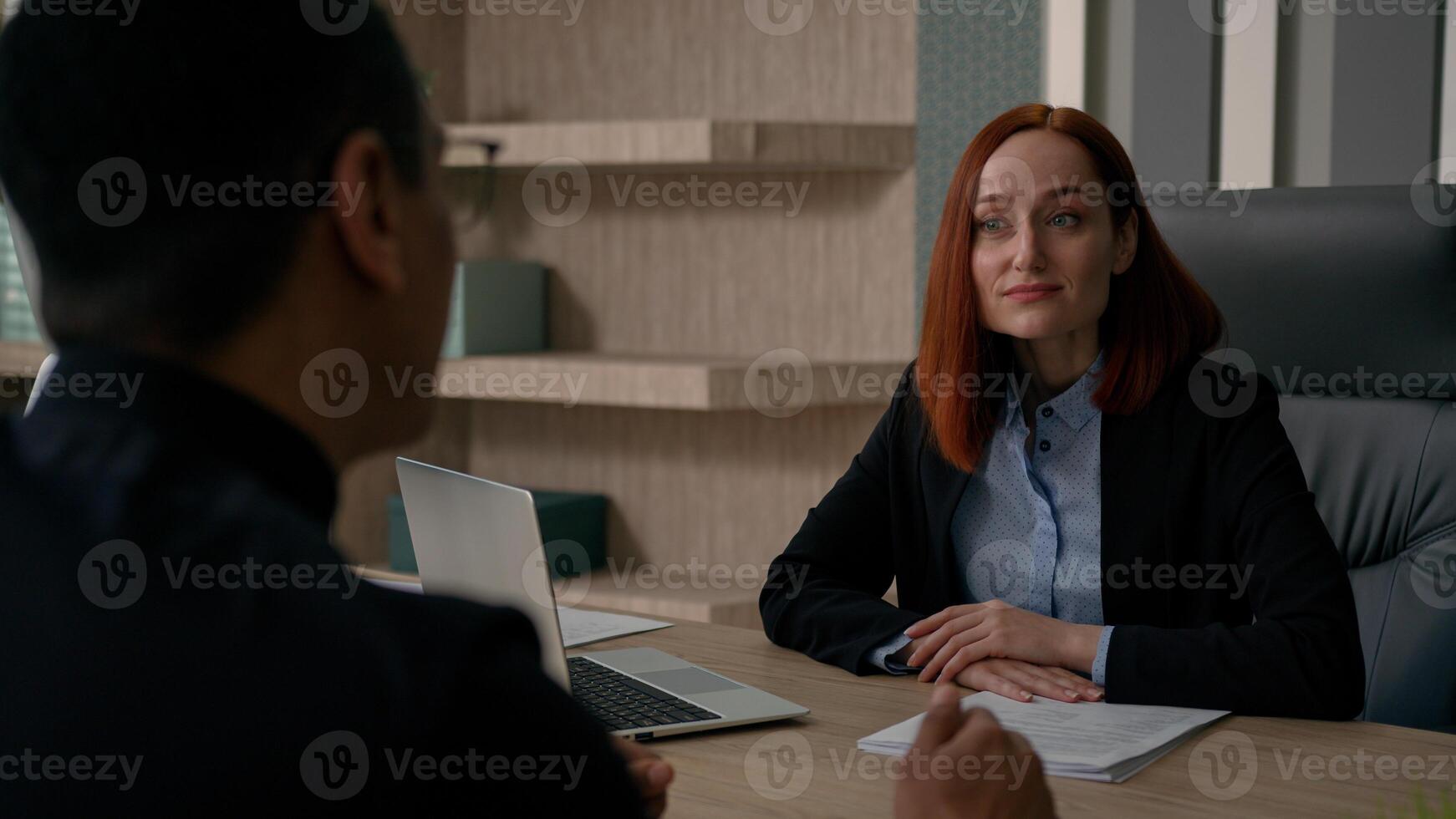 Diverse colleagues multiracial African American businessman and Caucasian businesswoman talk discuss online financial project with partner business consultation in office hire candidate negotiation photo
