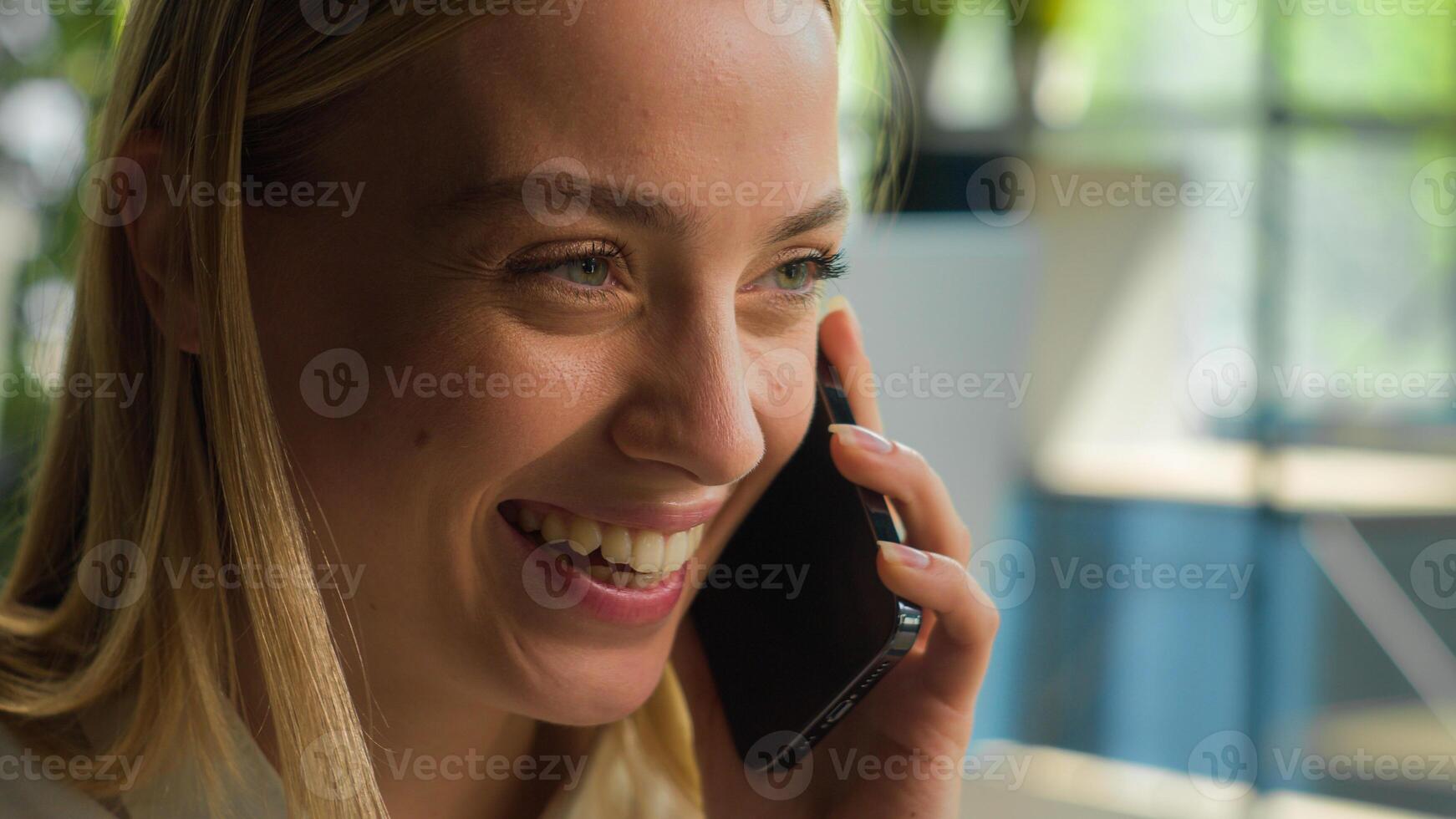 Close up head shot Caucasian businesswoman smiling girl talk mobile phone carefree woman laughing talking smartphone at office female employer manager speak chatter business conversation answer call photo