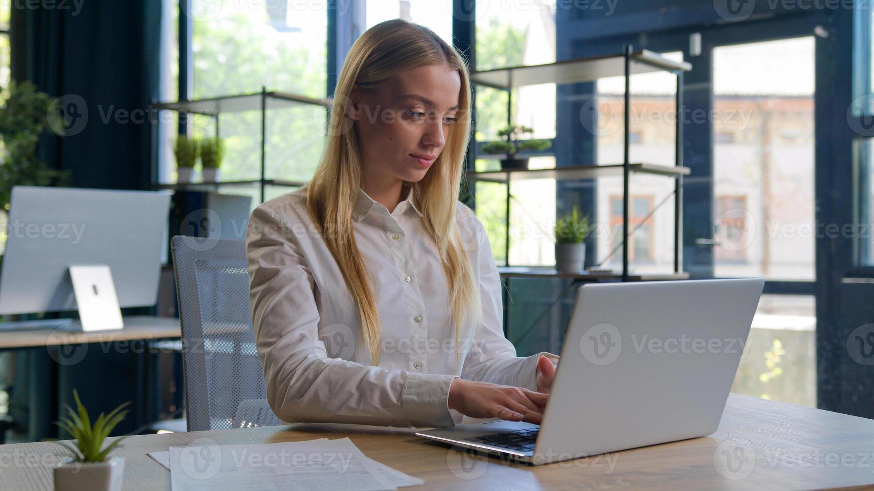 Caucasian woman working with business project online typing email on laptop at office smiling happy female businesswoman manager browsing internet computer e-commerce work studying cheerful girl smile photo
