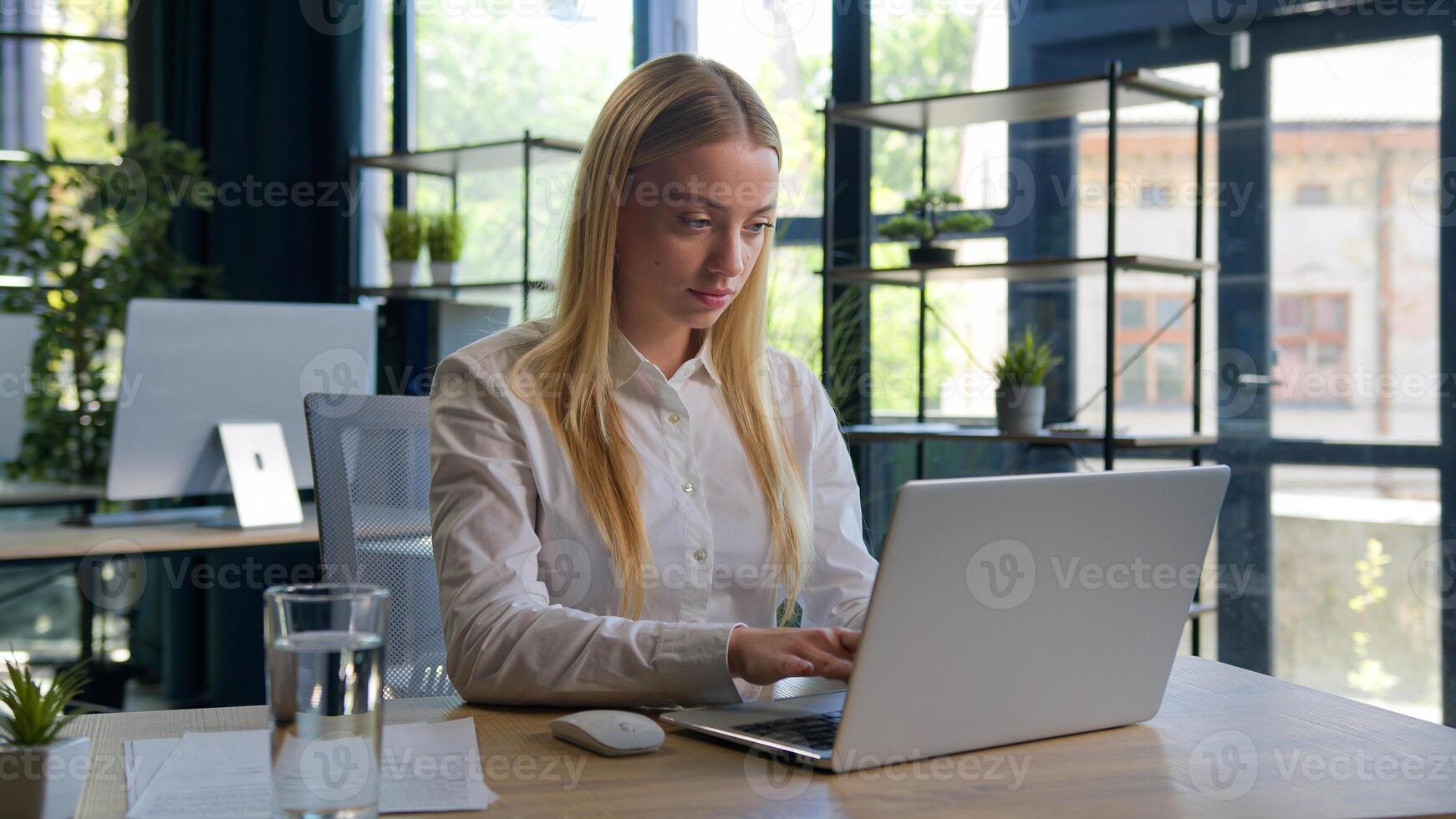 Caucasian woman working with business project online typing email on laptop at office smiling happy female businesswoman manager browsing internet computer e-commerce work studying cheerful girl smile photo