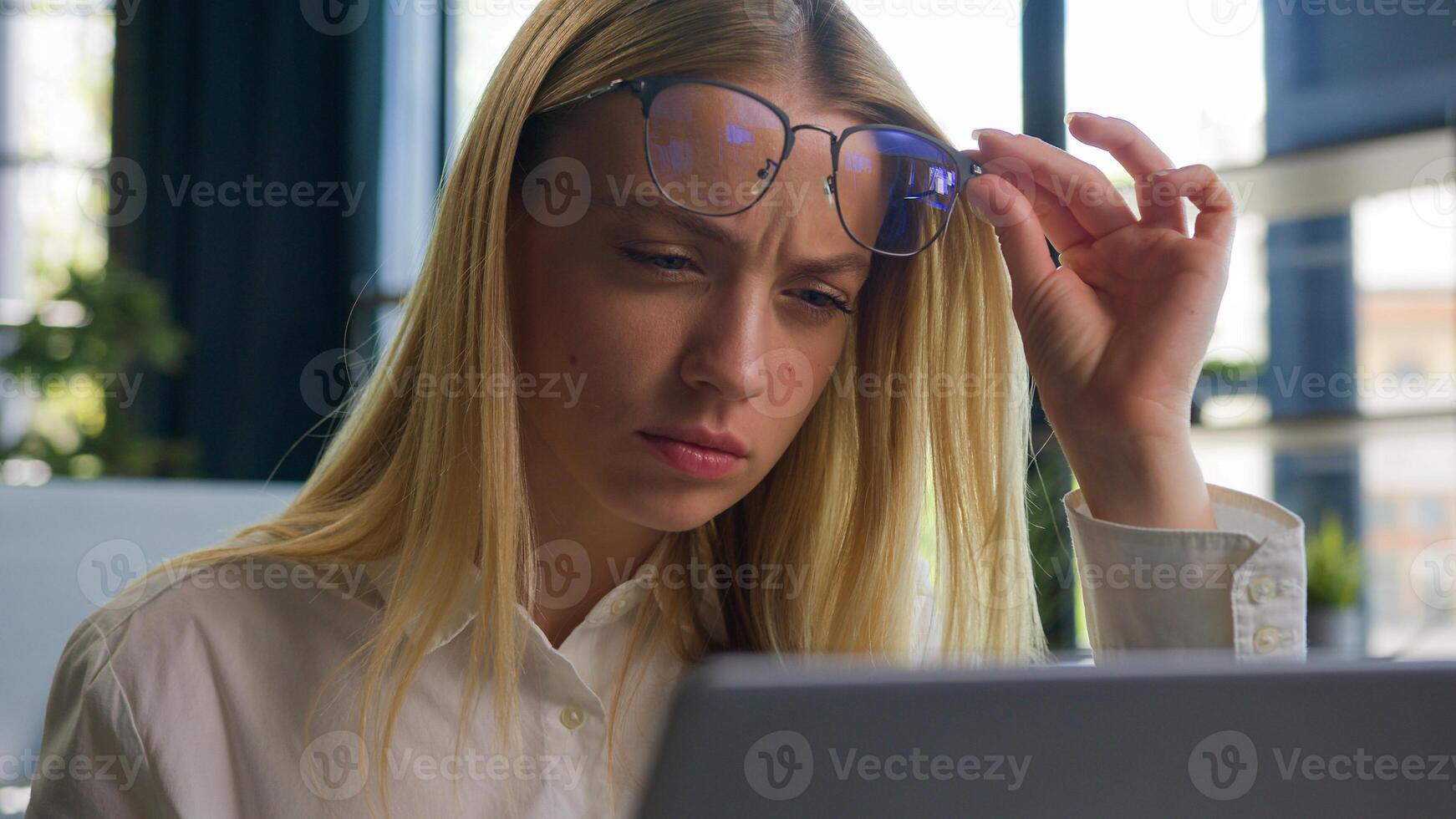 Confused Caucasian businesswoman in eyeglasses girl business woman employee take off glasses problem bad vision blurry sight reading on laptop overwork in office check eyesight ophthalmology service photo