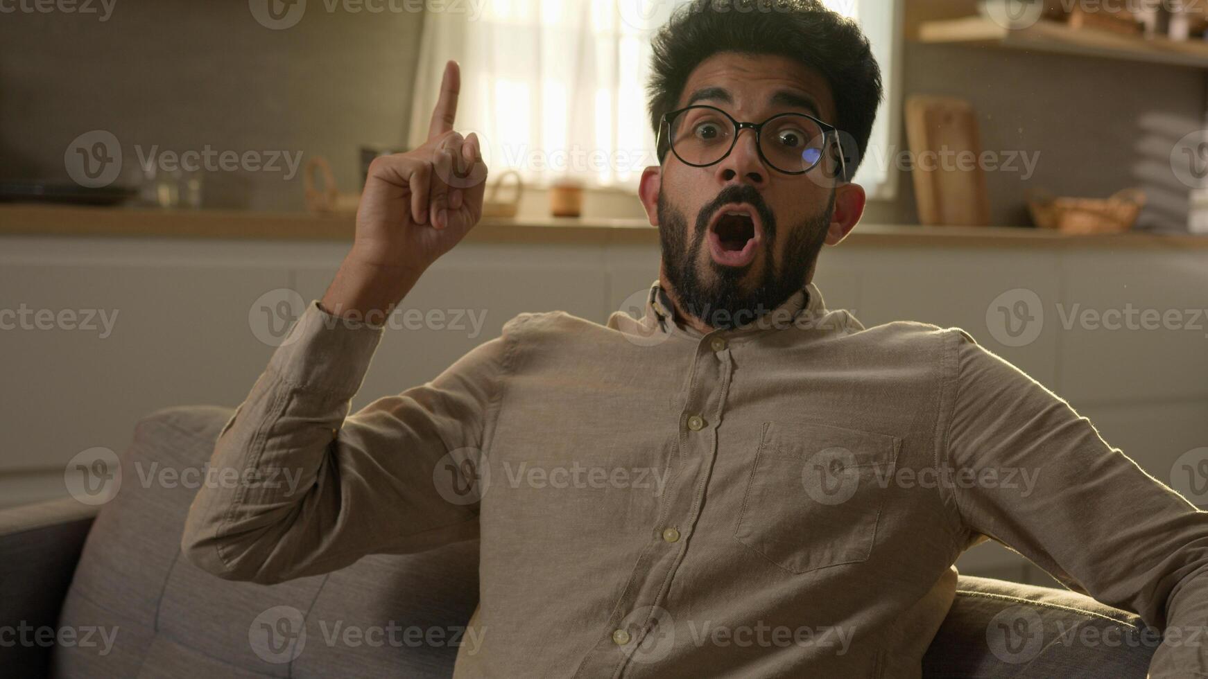 Arabian Indian homeowner man pensive thoughtful male think question ponder deep in thoughts dreaming creative brainstorming excited smart guy come up with idea happy insight gesture at home kitchen photo