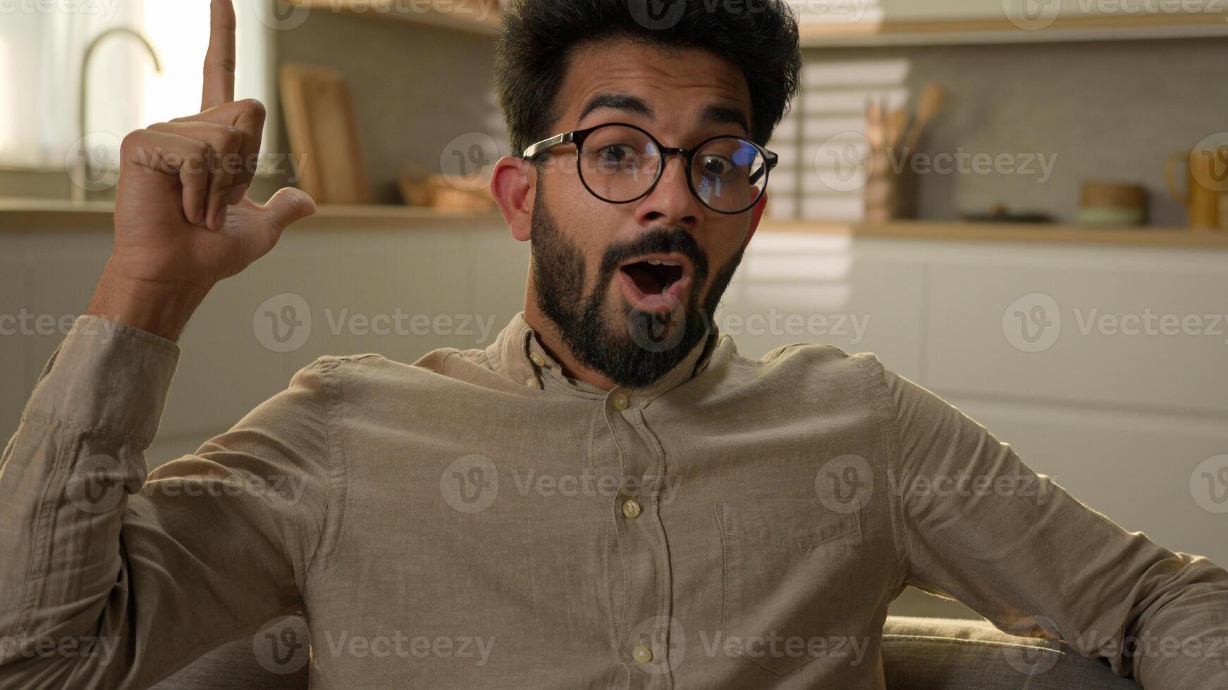 Arabian Indian homeowner man pensive thoughtful male think question ponder deep in thoughts dreaming creative brainstorming excited smart guy come up with idea happy insight gesture at home kitchen photo