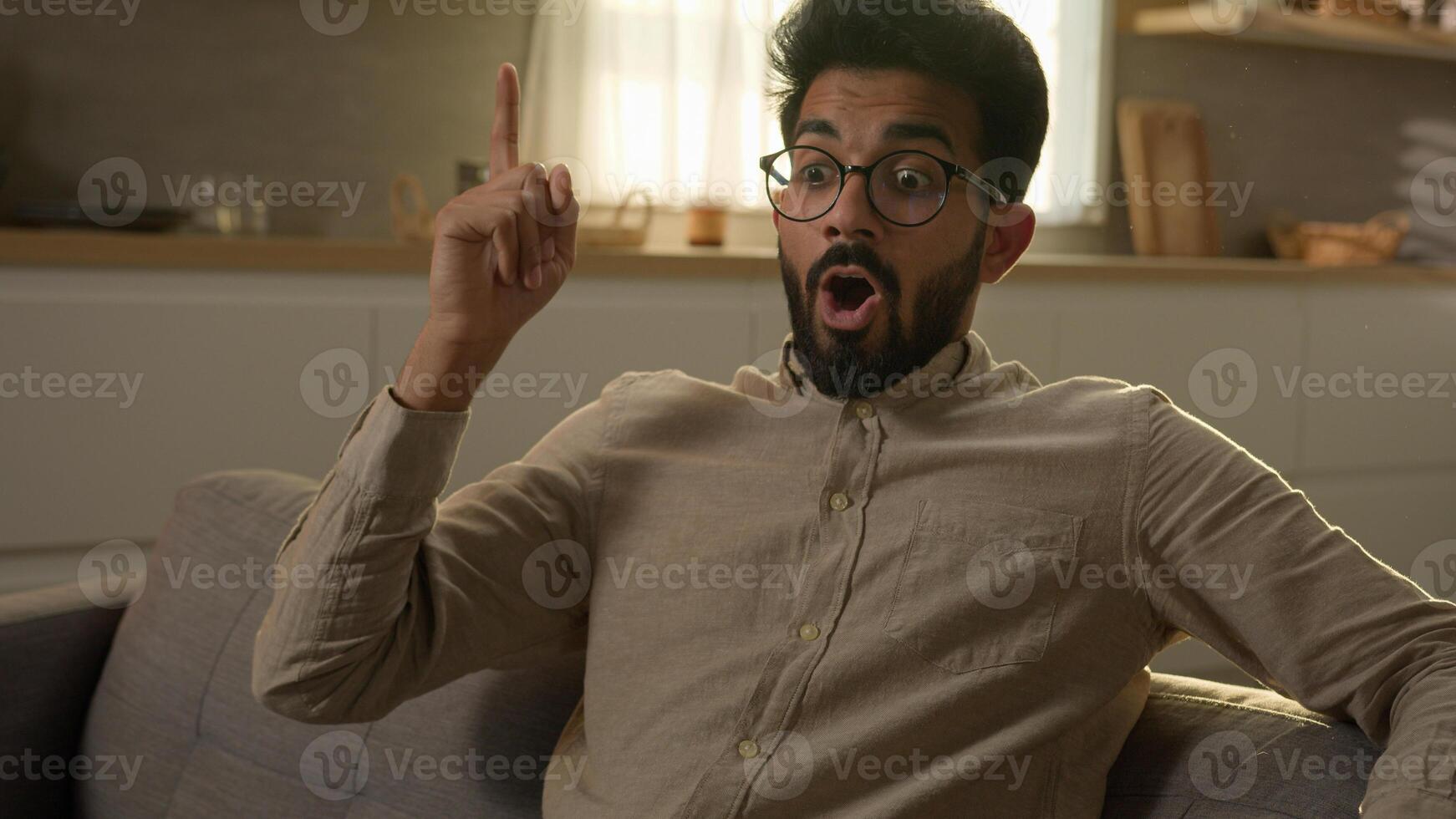 Arabian Indian homeowner man pensive thoughtful male think question ponder deep in thoughts dreaming creative brainstorming excited smart guy come up with idea happy insight gesture at home kitchen photo