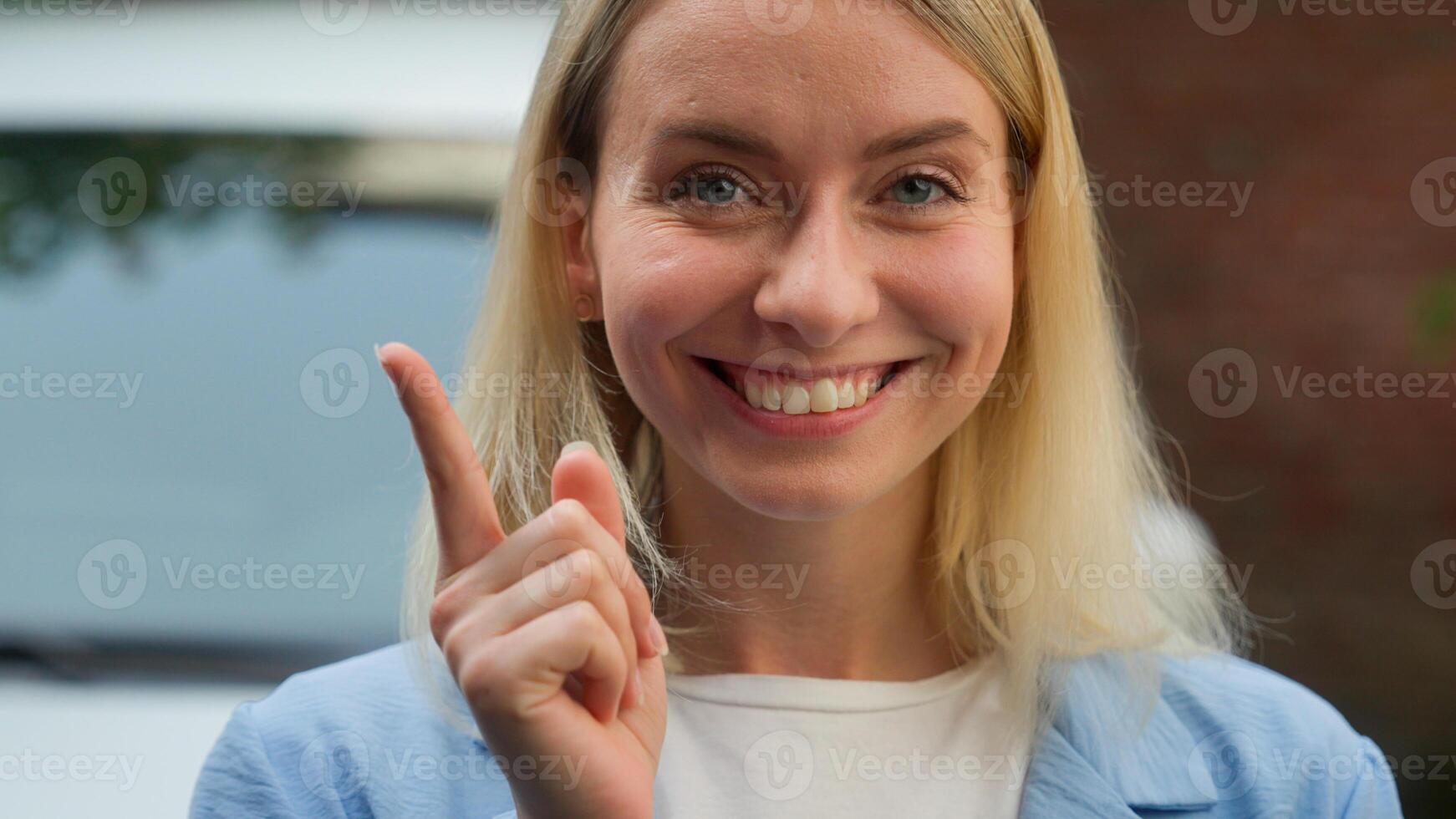 Puzzled contemplative Caucasian woman automobile buyer lady driver think of solution in city ponder car trouble difficulty girl businesswoman brainstorm auto problem consumer female raise finger idea photo