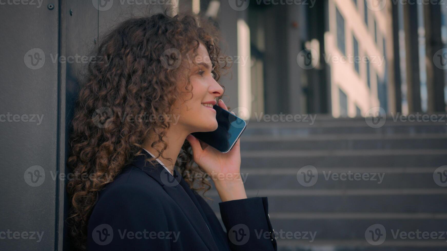 Caucasian businesswoman employer female manager girl talking smartphone near office building wall outside young business woman entrepreneur talk phone discuss with client outdoors mobile call chatting photo