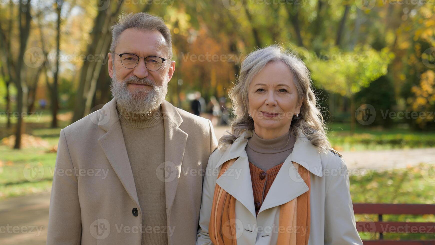 Happy family Caucasian middle-aged couple love in autumn park retired 60s man woman cheerful smile smiling in city outdoors two grandparents senior mature gray haired wife husband together health care photo
