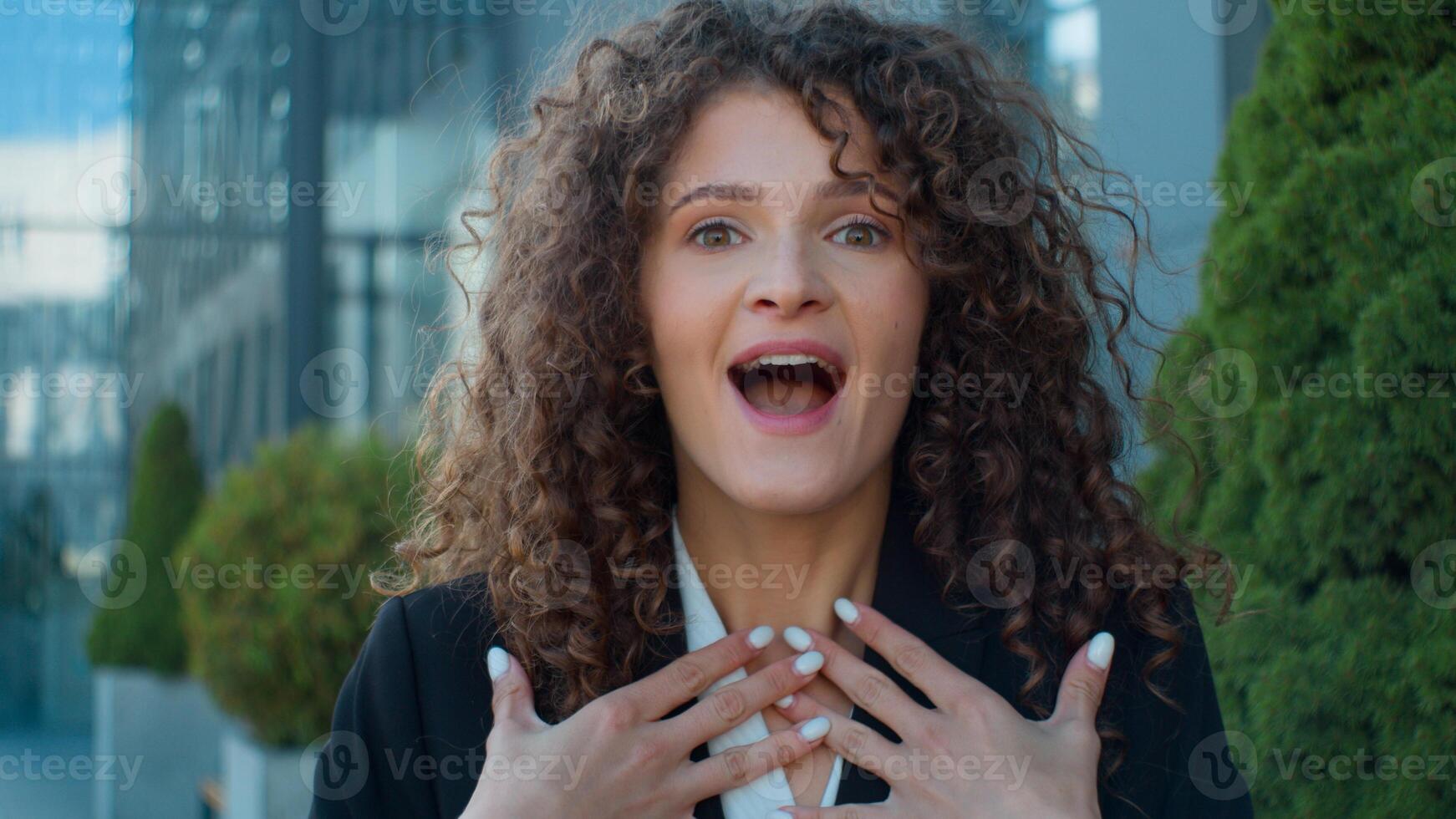 Outdoors business portrait Caucasian amazed shocked young girl woman looking at camera open mouth wow shock wonder amazement surprise female happy businesswoman employer worker amazing news in city photo