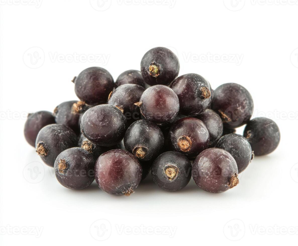 Fresh black currants arranged in a pile on a plain background showcasing their rich color and texture photo