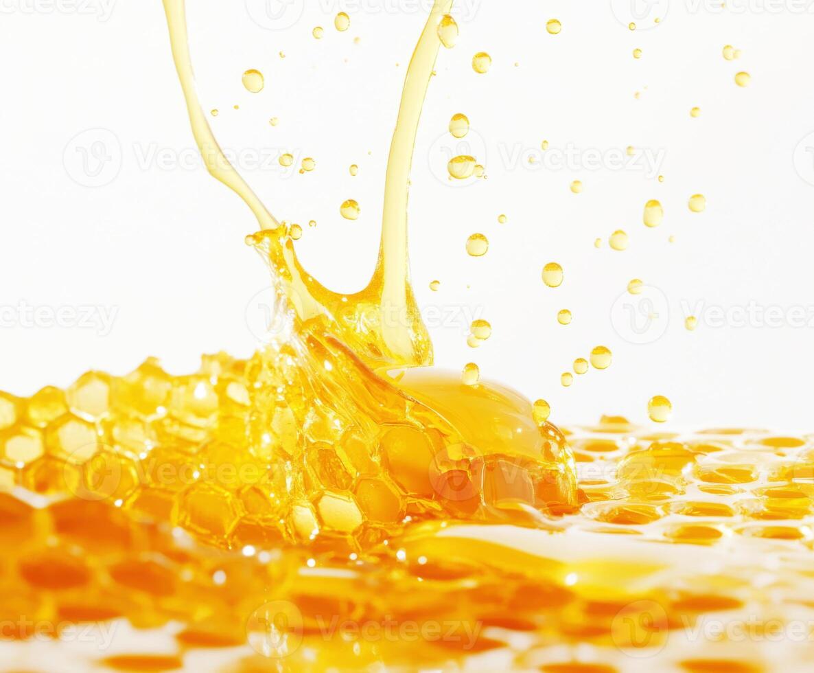 Golden honey splashes over honeycomb with vibrant droplets reflecting sunlight photo