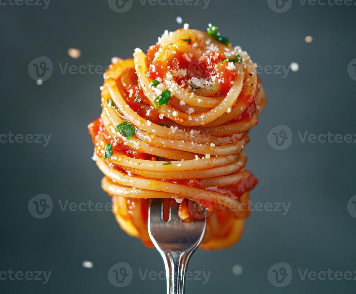 Delicious spaghetti with marinara sauce and herbs twirled on a fork ready to be enjoyed photo